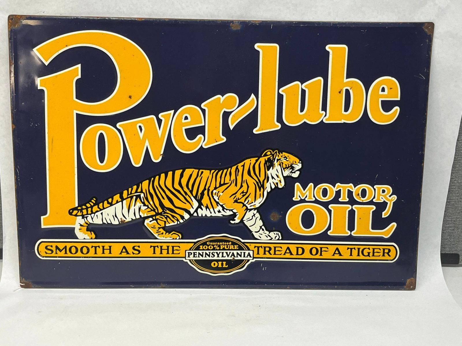 Power-lube Tiger Motor Oil Sign: This is a single-sided advertising sign for Power-lube Motor Oil featuring porcelain enamel on a heavy-gauge steel substrate. To the right of the tiger are the words MOTOR OIL in yellow and white text
