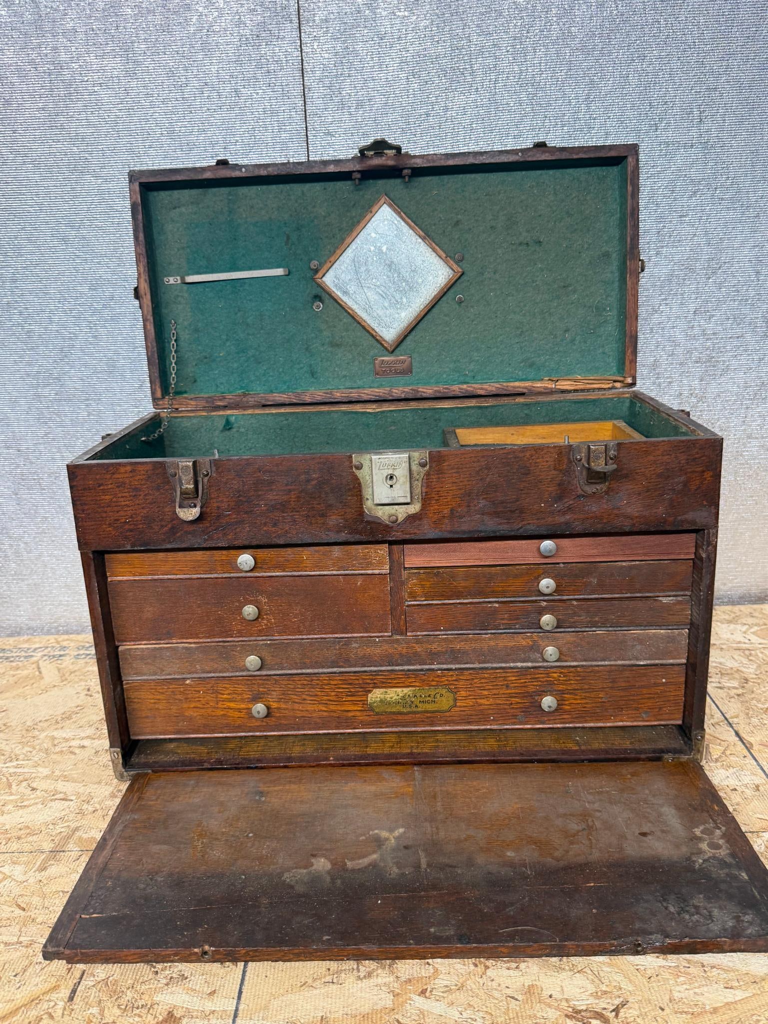 Lufkin Rule Co. Oak Machinist Chest: A portable machinist tool chest constructed of quartersawn oak with steel and brass hardware. The interior of the lid is lined with green felt and holds a diamond-shaped mirror set in a wood frame. A 