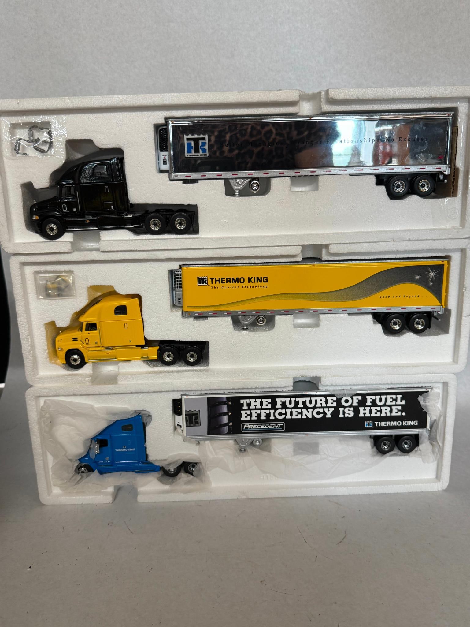 3 Mack Vision Die-Cast Tractor-Trailers: A set of three 1:64 scale promotional die-cast model tractor-trailers produced for Thermo King. Each unit consists of a Mack Vision sleeper-cab tractor with a detachable refrigerated trailer,