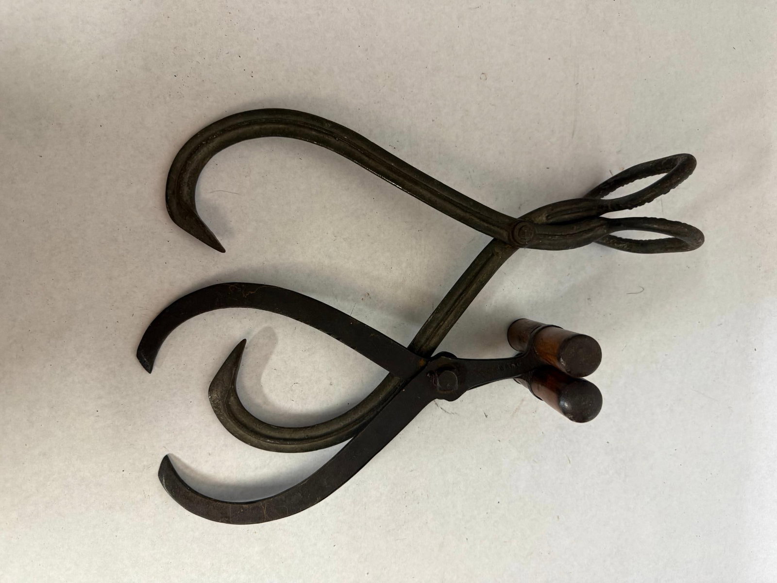 G.W. Bradley Iron Ice Harvesting Tools: Two late nineteenth-century iron tools for ice harvesting, manufactured by G.W. An embossed inscription on the interior of the handle loop reads G. A stamped mark on the side of the iron arm near the