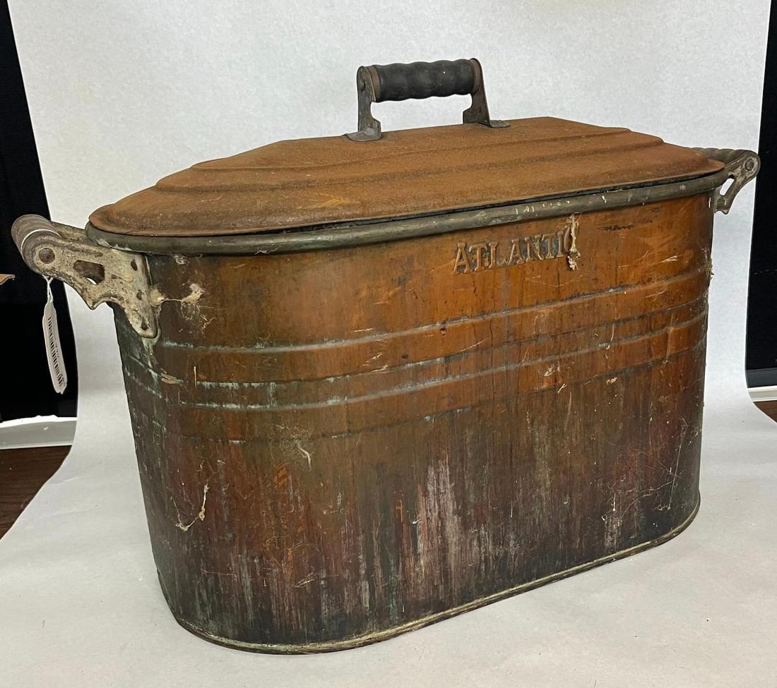 Atlantic Stamping Copper Wash Boiler: An American utilitarian copper wash boiler manufactured by the Atlantic Stamping Company in Rochester, New York. The vessel is constructed with an oval sheet copper body featuring seamed joints and a