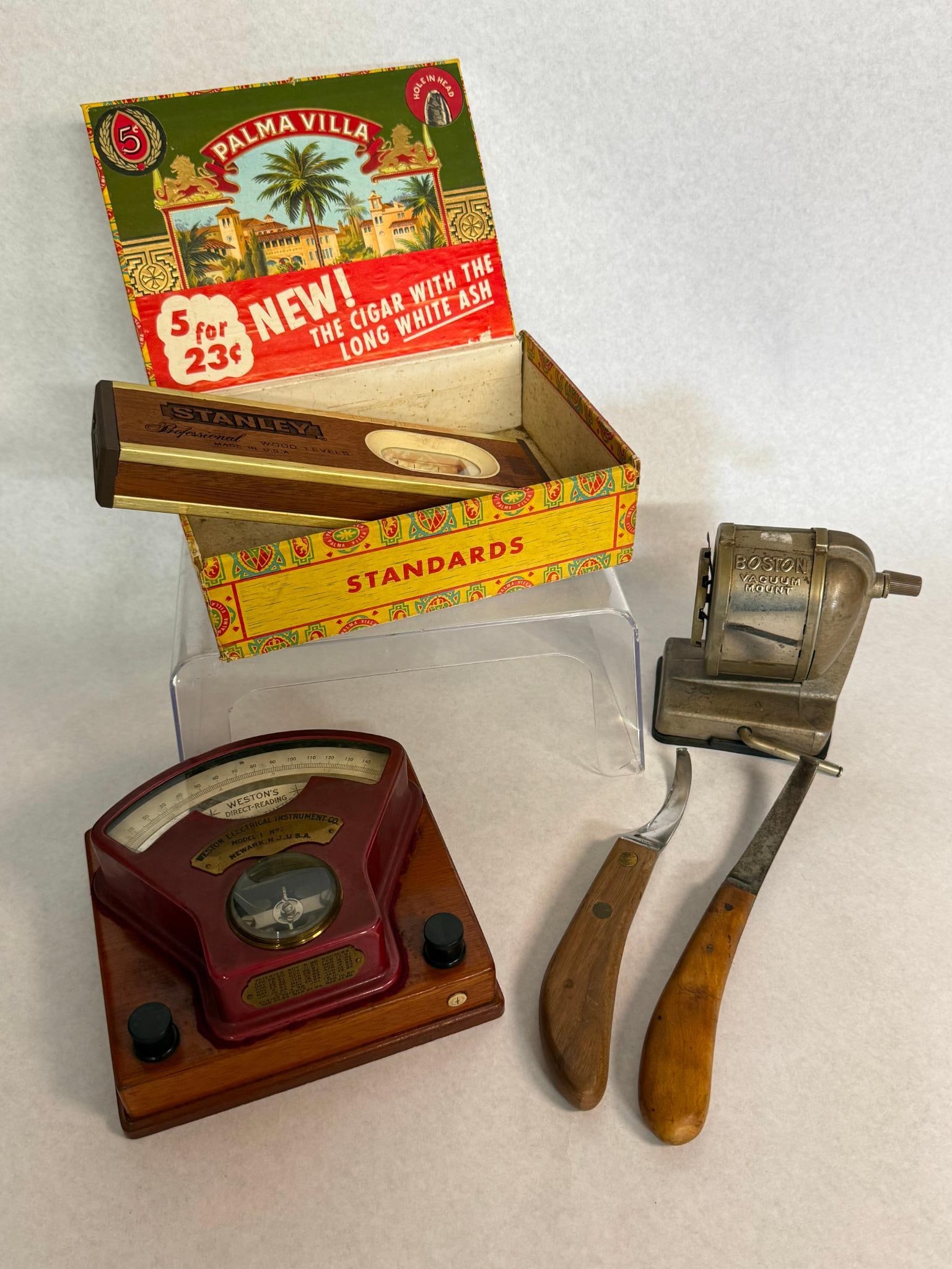 Weston, Boston & Stanley Tool Lot: This collection features an assortment of industrial, office, and hand tools. It is constructed with a red-painted metal housing mounted on a polished mahogany wood base. The instrument features a
