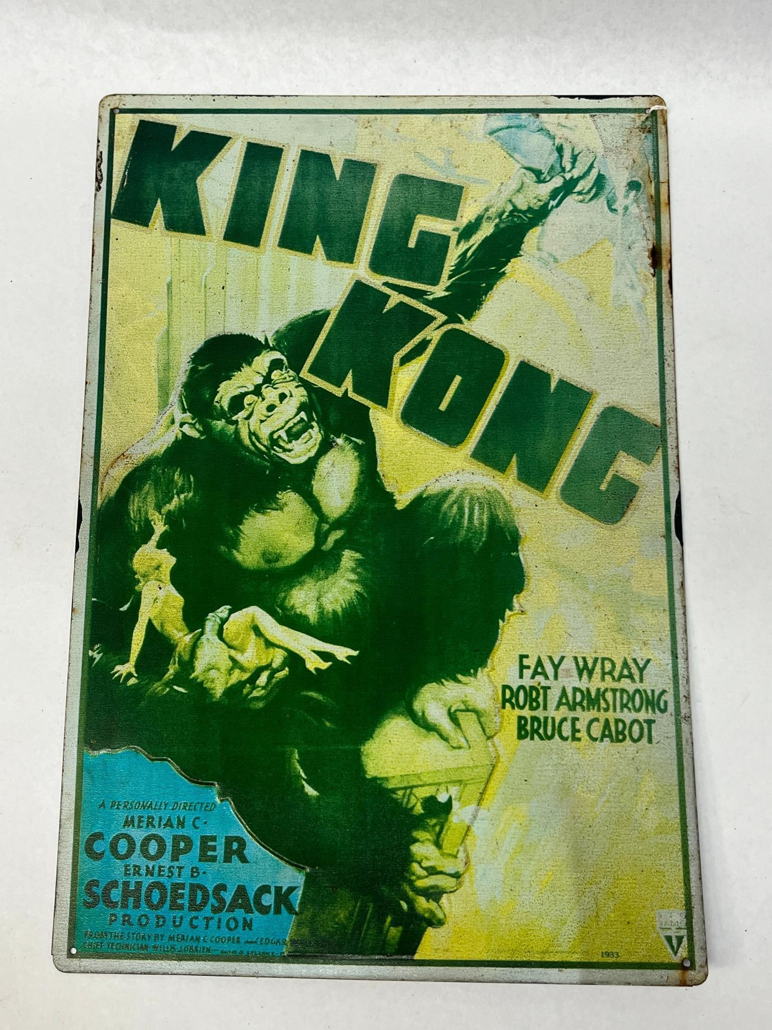 King Kong 1933 Movie Poster Metal Sign: A rectangular metal sign featuring the promotional artwork for the 1933 RKO Radio Pictures film King Kong. The front of the sign includes printed text for the title, starring actors Fay Wray, Robert