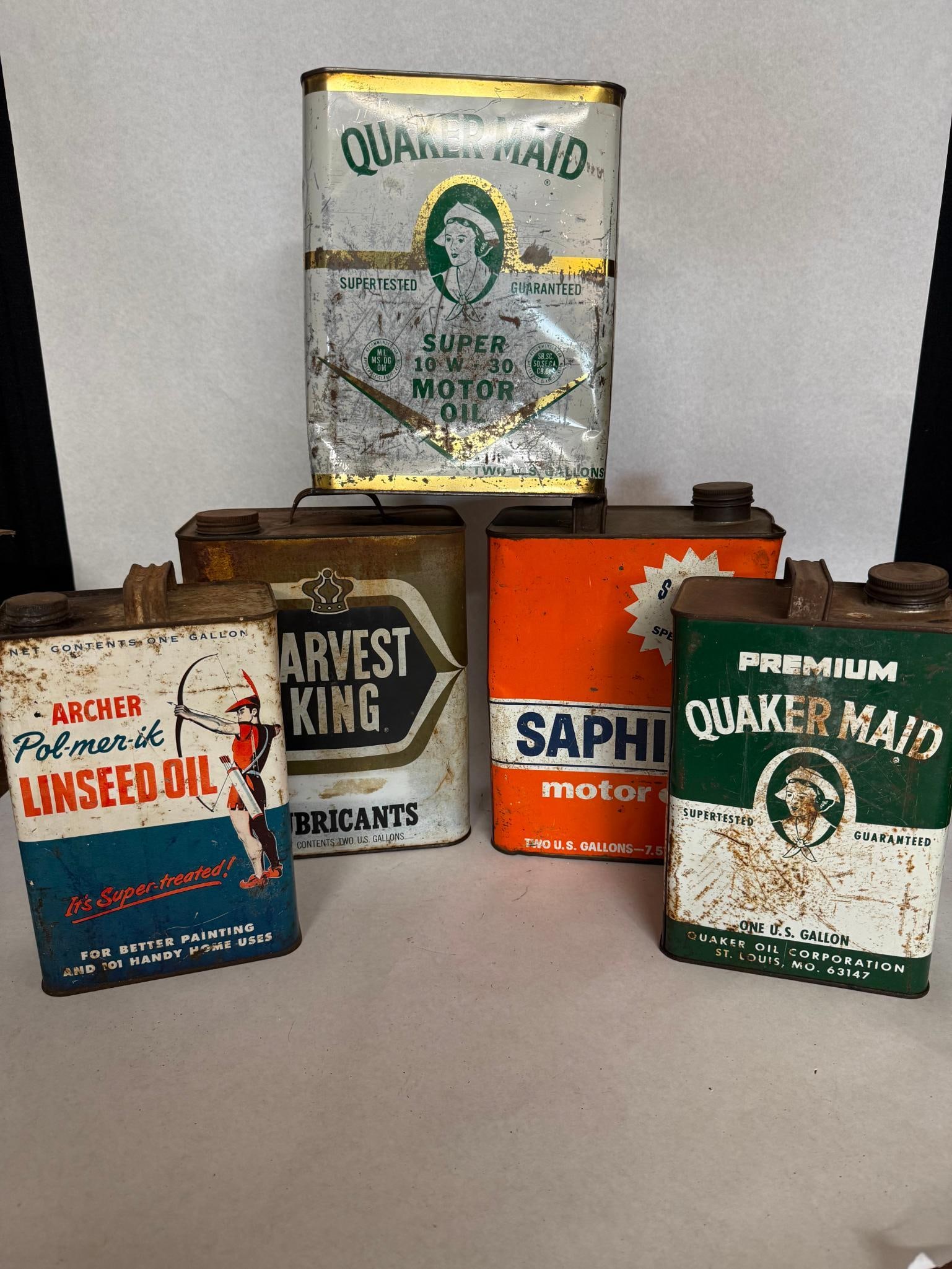 Lithographed Tin Motor Oil Cans: This collection of rectangular lithographed tin containers features various automotive and industrial fluids originating from the United States, dating primarily from the mid-to-late 20th century. The