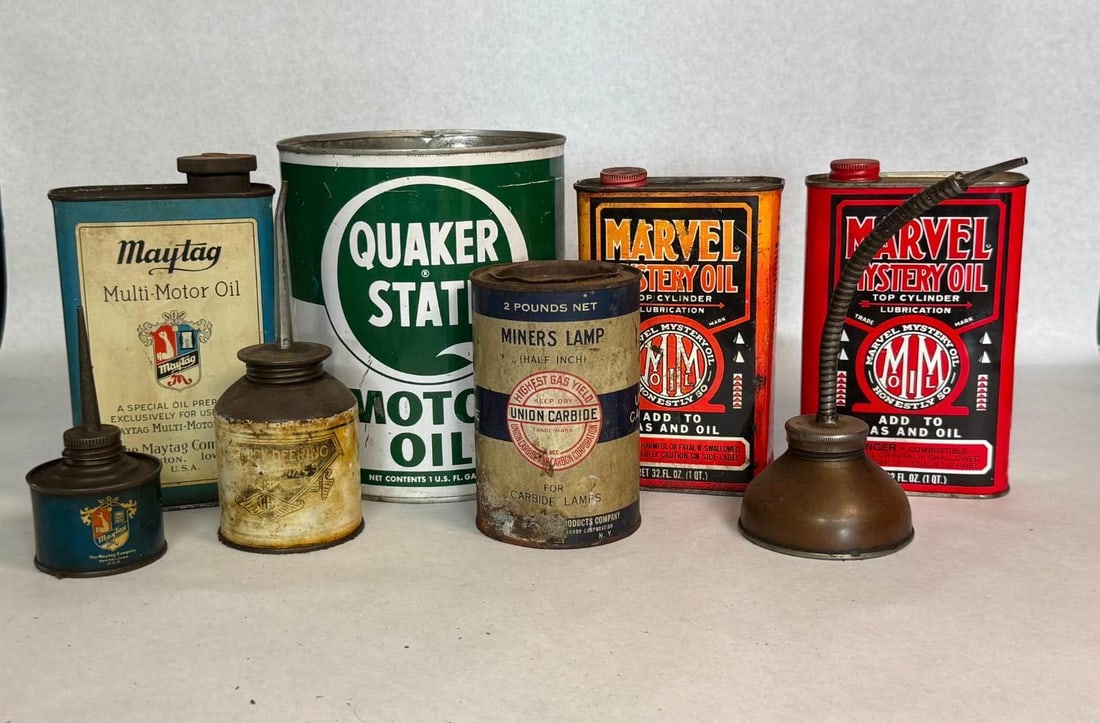 8 Maytag & Marvel Mystery Oil Cans: An assortment of eight mid-century containers and oilers for automotive, agricultural, and industrial applications. The collection includes lithographed tins, paper-labeled oilers, and metal pump