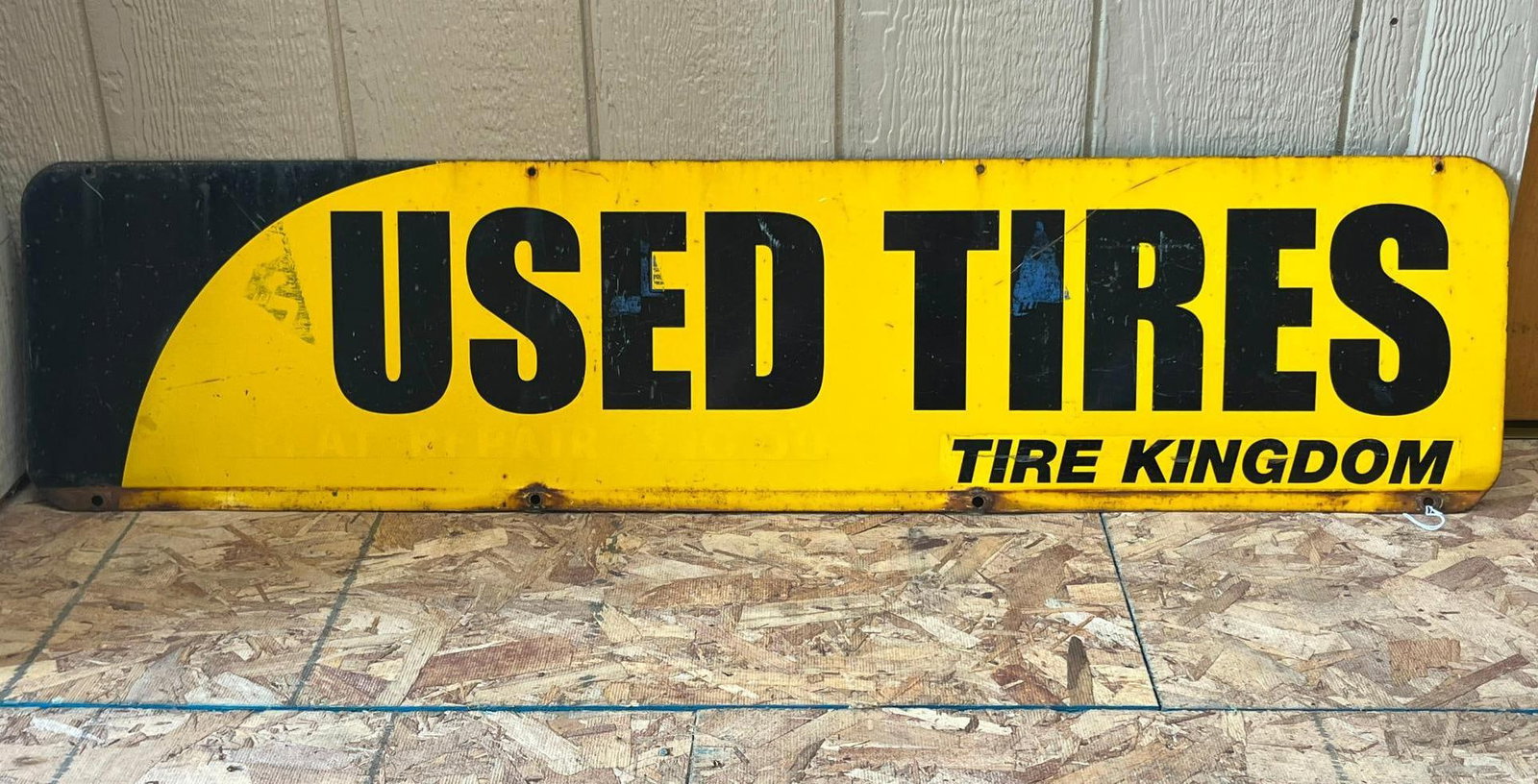 Tire Kingdom Metal Used Tires Sign: This is a large horizontal rectangular metal advertising sign featuring a high-contrast color scheme of black graphics on a yellow field. The main body of the sign contains bold black block lettering 