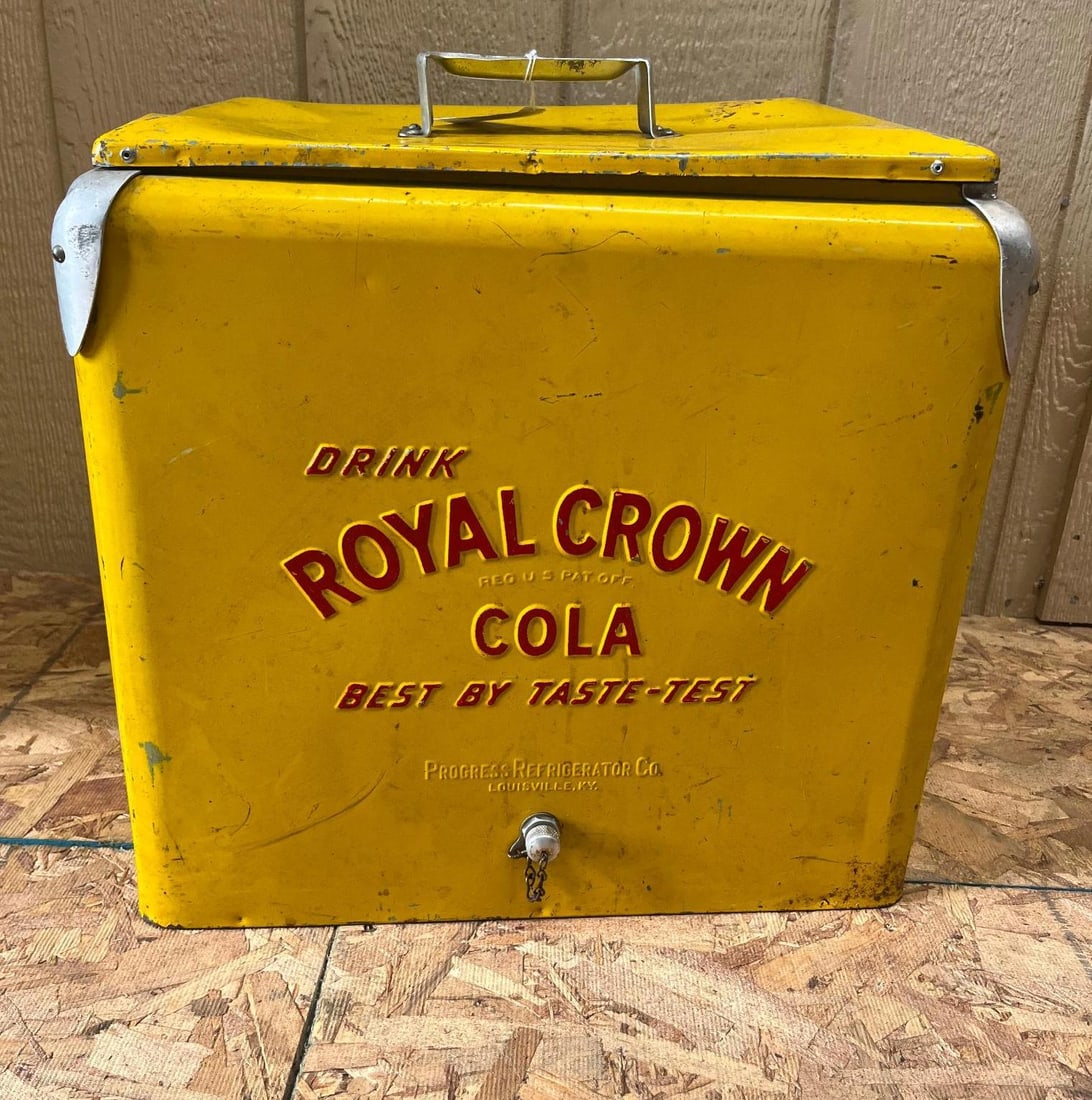 Royal Crown Cola Metal Cooler, Progress: This mid-century portable ice chest is constructed from steel with a yellow painted exterior and a galvanized metal interior. The front face features embossed and painted lettering reading DRINK