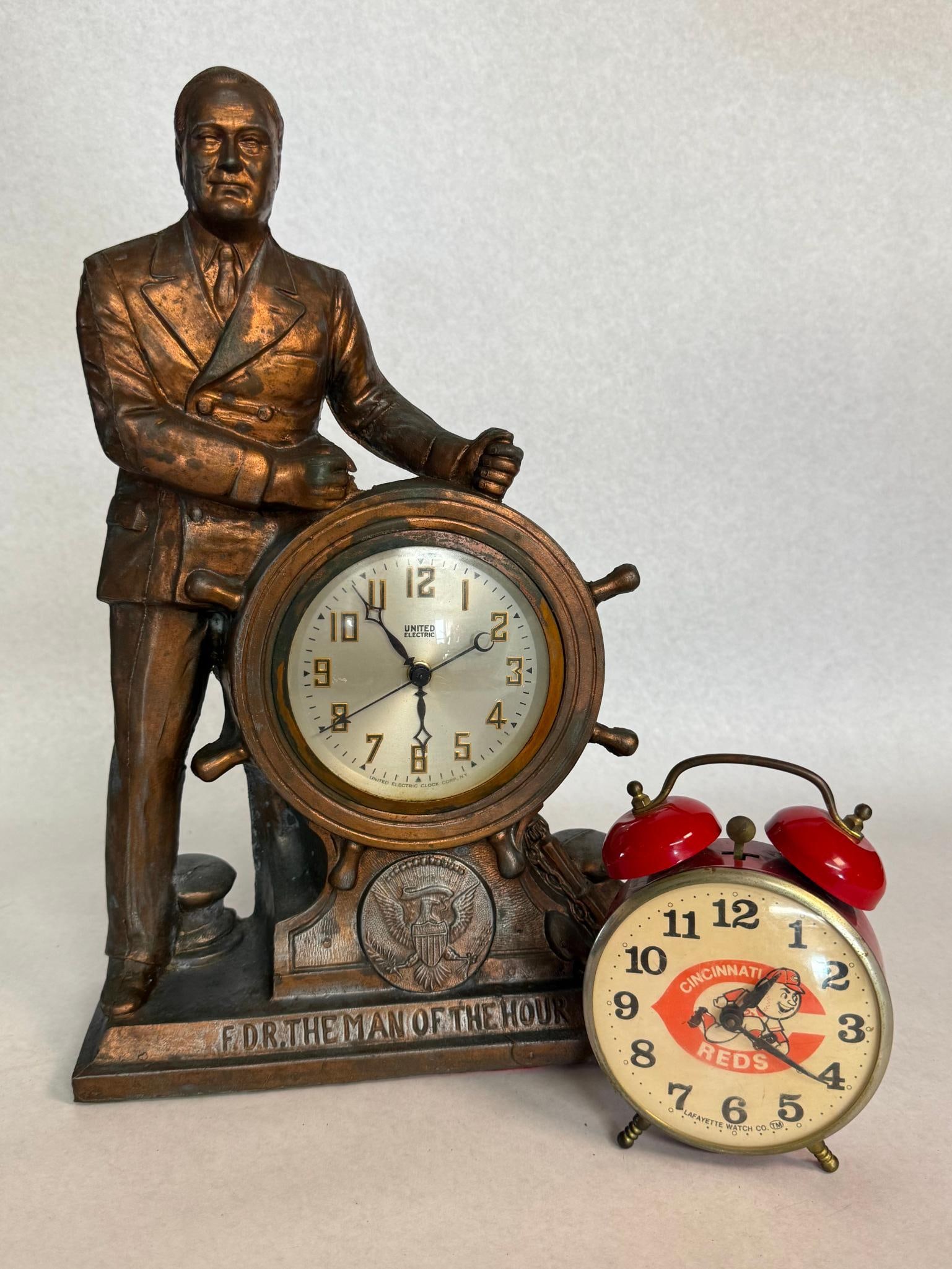 United FDR Clock & Lafayette Reds Clock: This lot comprises two American-interest timepieces. The cast metal case features a copper-toned electroplated finish and depicts President Franklin D. The rectangular base is embossed with the text