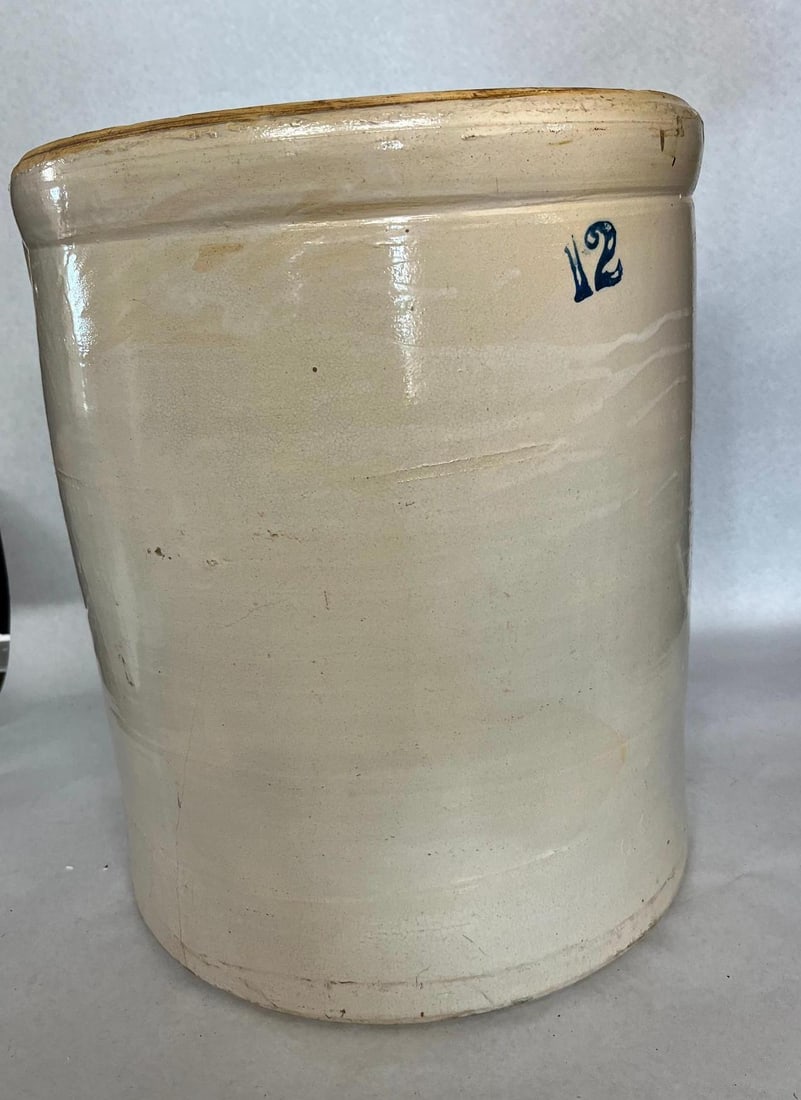 American Two Tone Stoneware Crock: This is a large capacity American stoneware utility crock of cylindrical form featuring a thick molded rim. There are no maker marks stamps signatures or labels visible on the piece. Measurements: 12