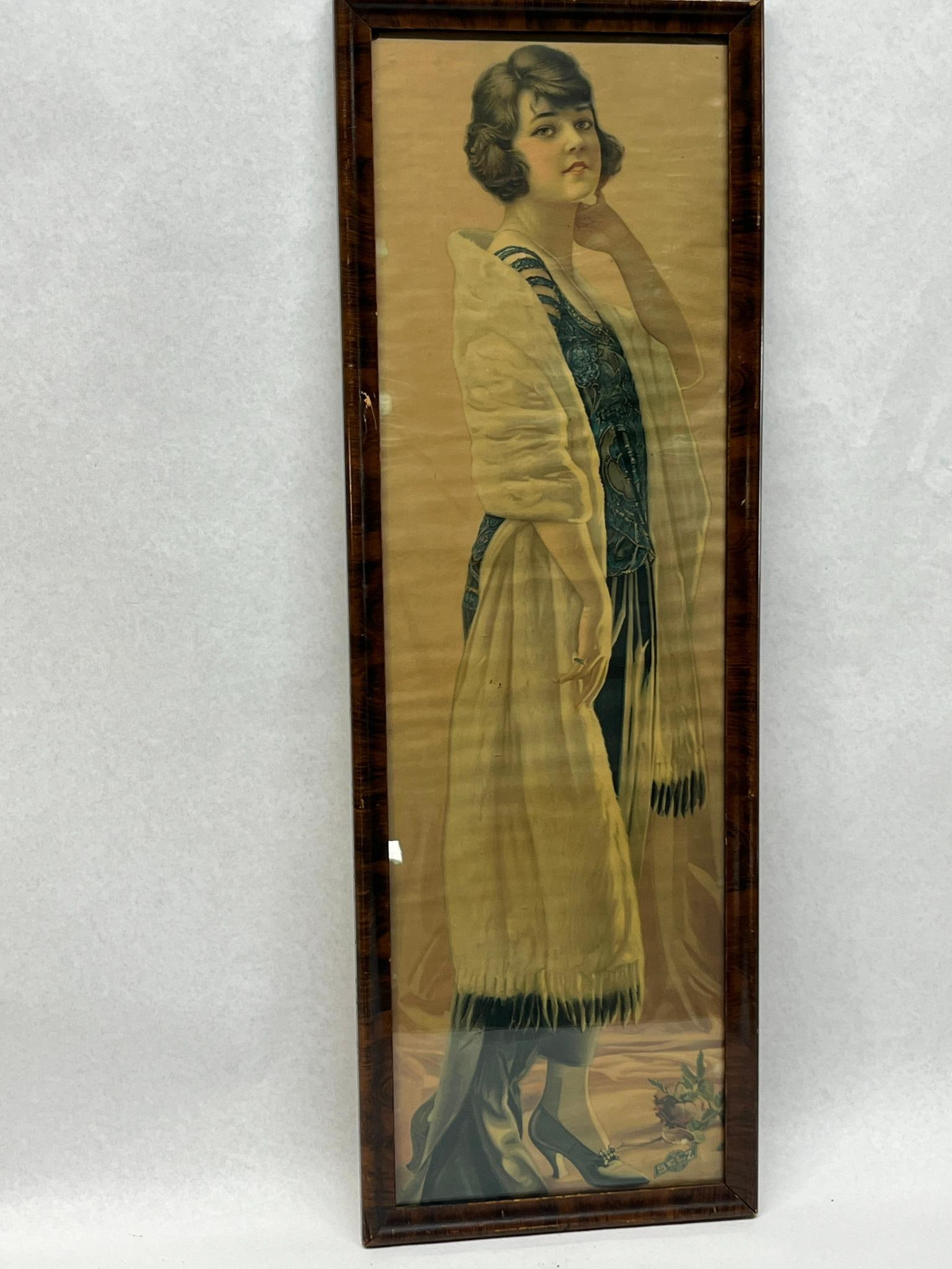 Selz Shoes 1920s Chromolithograph Print: A vertical chromolithograph advertising print in a yard long format, dating to the 1920s. The print is housed in a narrow wooden frame with a dark, faux-figured wood grain finish and is protected by g