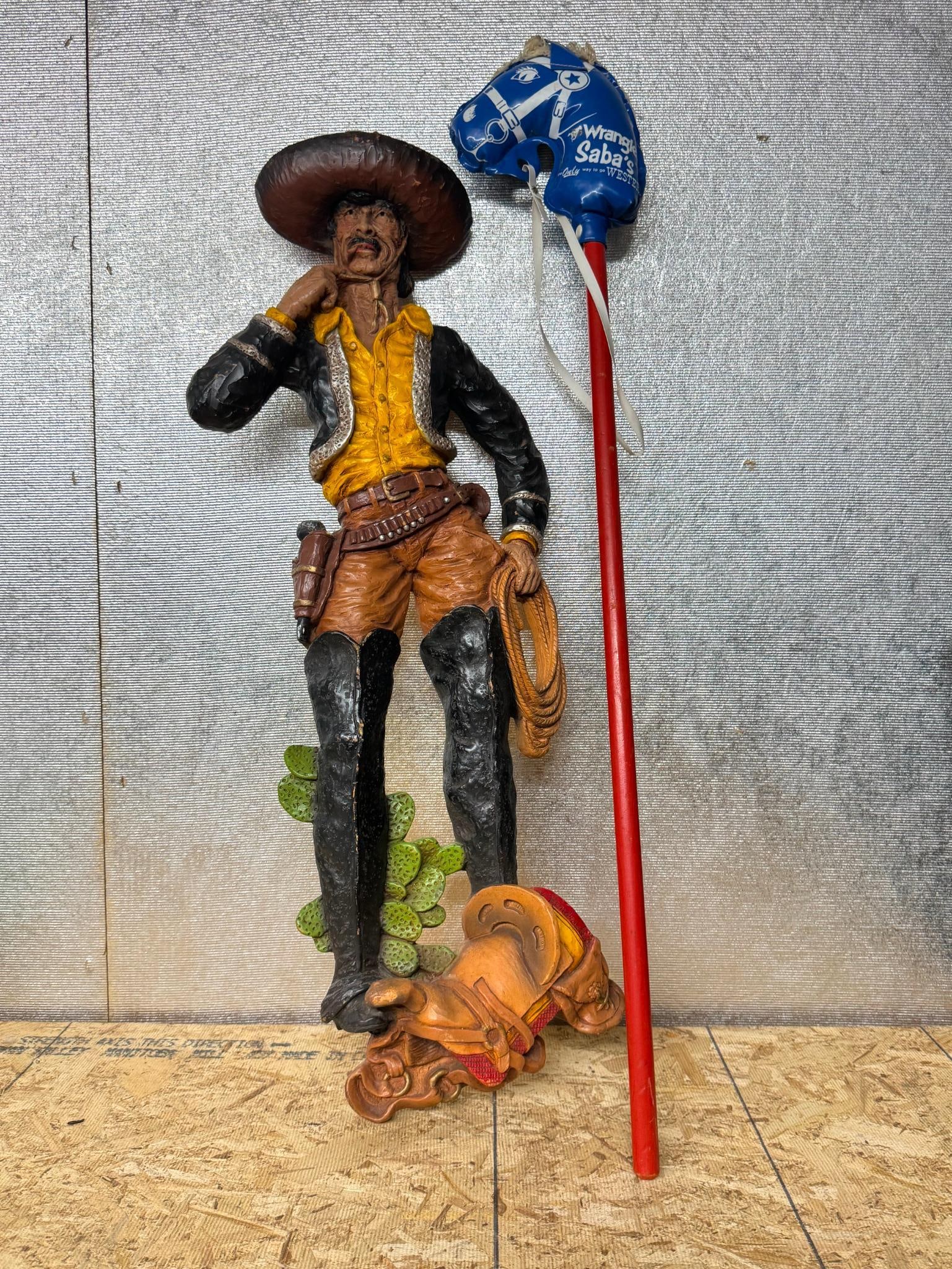 Vaquero Wall Plaque & Saba Hobby Horse: This lot consists of two Western-themed decorative and promotional items. The item is constructed from molded resin or plastic with a hollow reverse side. A red script mark reading Handmade is