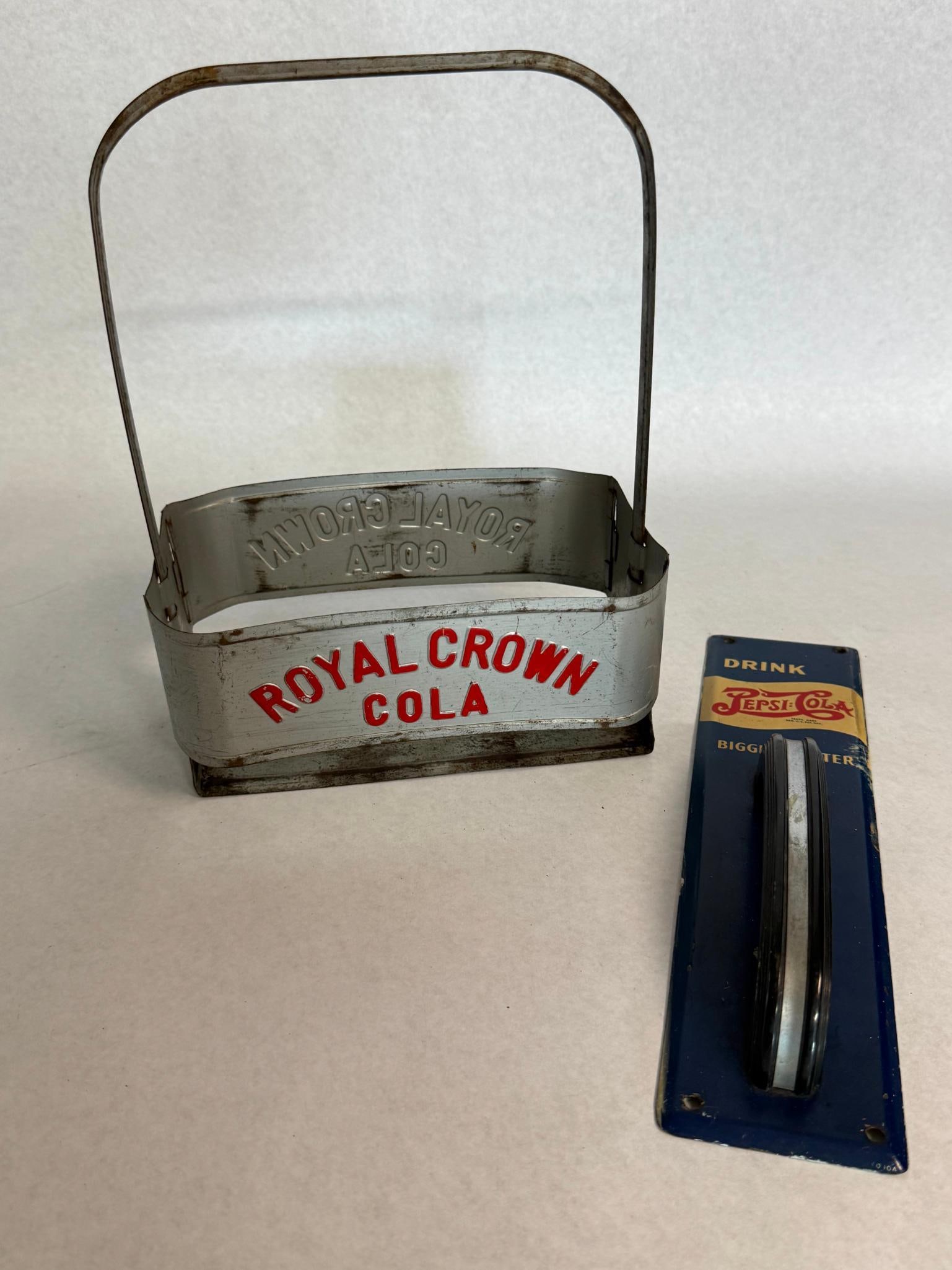 RC Cola Carrier & Pepsi Push Plate: This lot consists of two American soda advertising items. The arched top line of the embossed text reads ROYAL CROWN and the second line reads COLA. The second item is a vertical rectangular