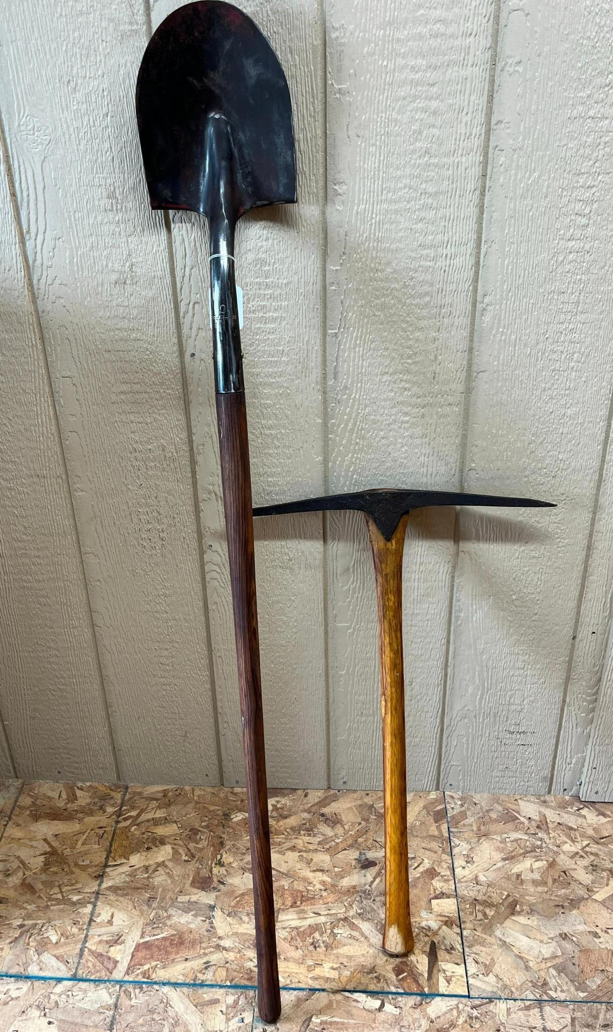 Pair American Shovel & Pickaxe: This lot features two manual excavation tools of American origin. The first is a round-point digging shovel constructed with a steel blade, a closed-back socket, and a turned step for foot placement.