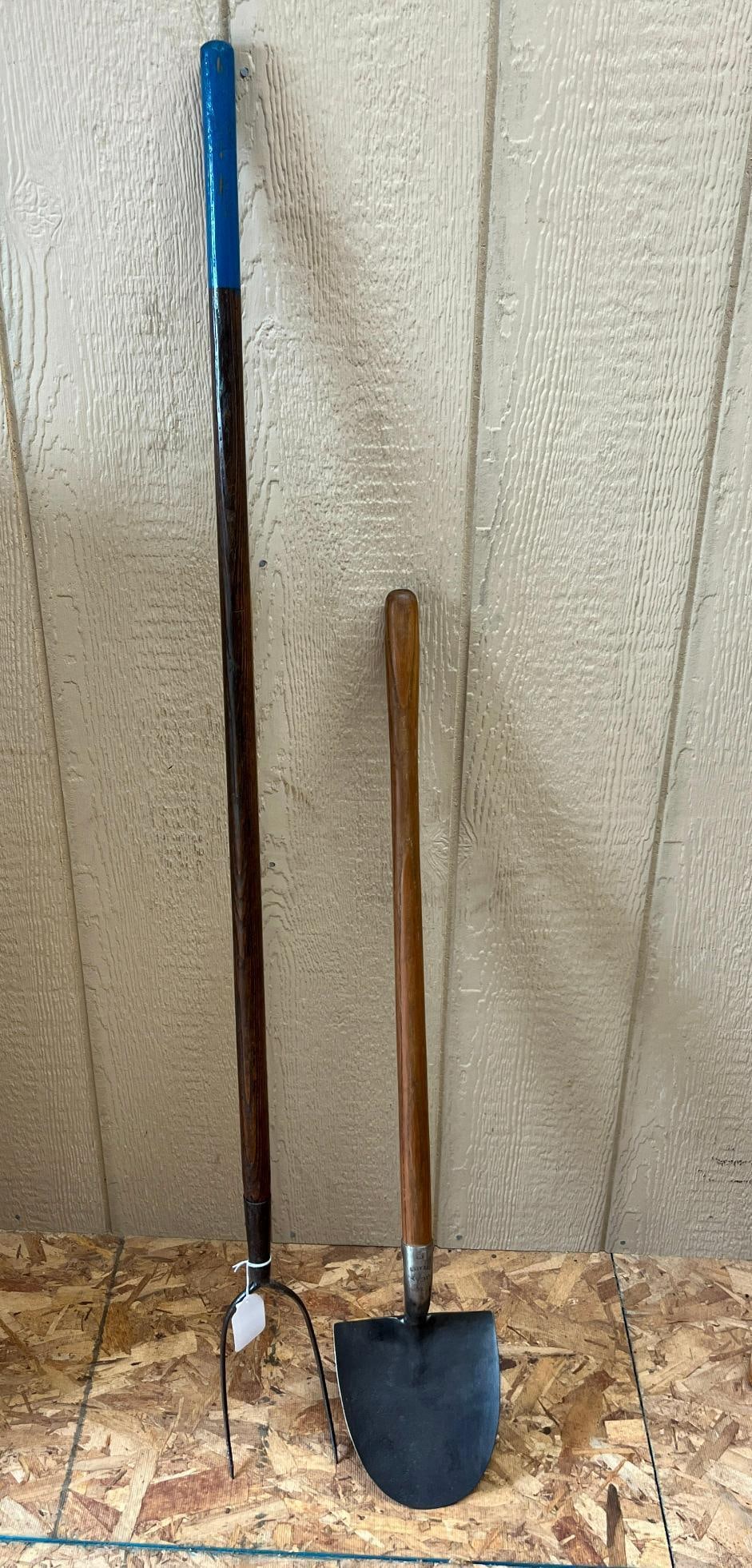 Pair Hay Fork & Short-Handled Spade: This lot consists of two agricultural hand tools. The first item is a two-tine hay fork featuring a forged steel head with two curved, pointed tines. The second item is a short-handled round-point