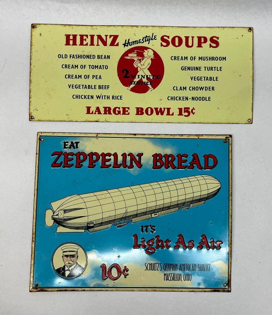 Heinz & Zeppelin Embossed Metal Signs: A pair of retro-style embossed sheet metal advertising signs. The center features a red circular logo with a silhouette of a waiter carrying a tray and text reading 2 MINUTE SERVICE. The bottom edge i
