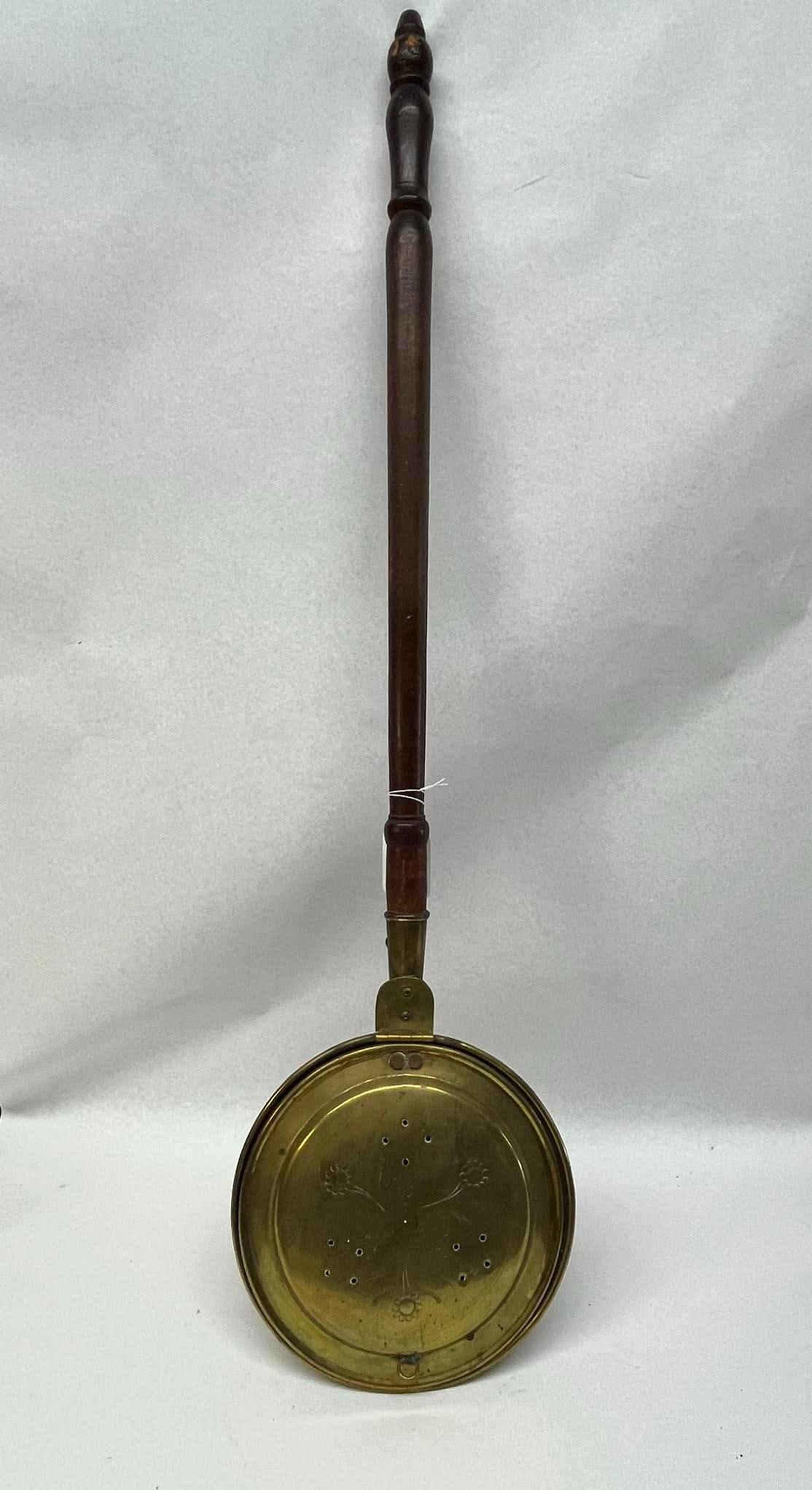Brass Warming Pan, Engraved Lid & Wood: This antique bed warmer consists of a circular brass pan with a hinged, domed lid and a long, turned wooden handle. The brass lid is decorated with hand-engraved floral and foliate motifs,