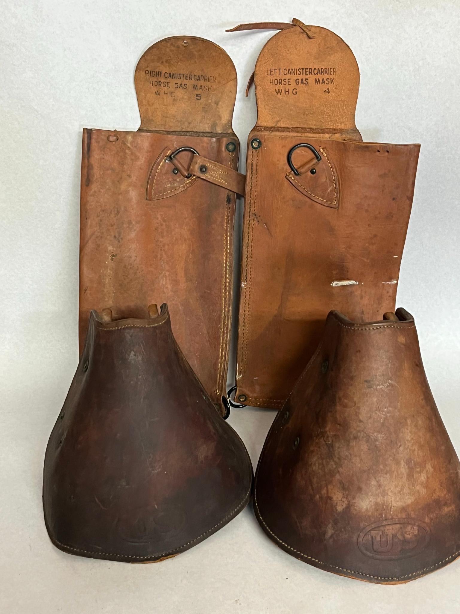 US Army WWI Horse Gear & M1904 Stirrups: This collection consists of russet leather equine field equipment issued to the United States Army during the World War I era. The canister carriers are constructed of heavy russet leather with steel