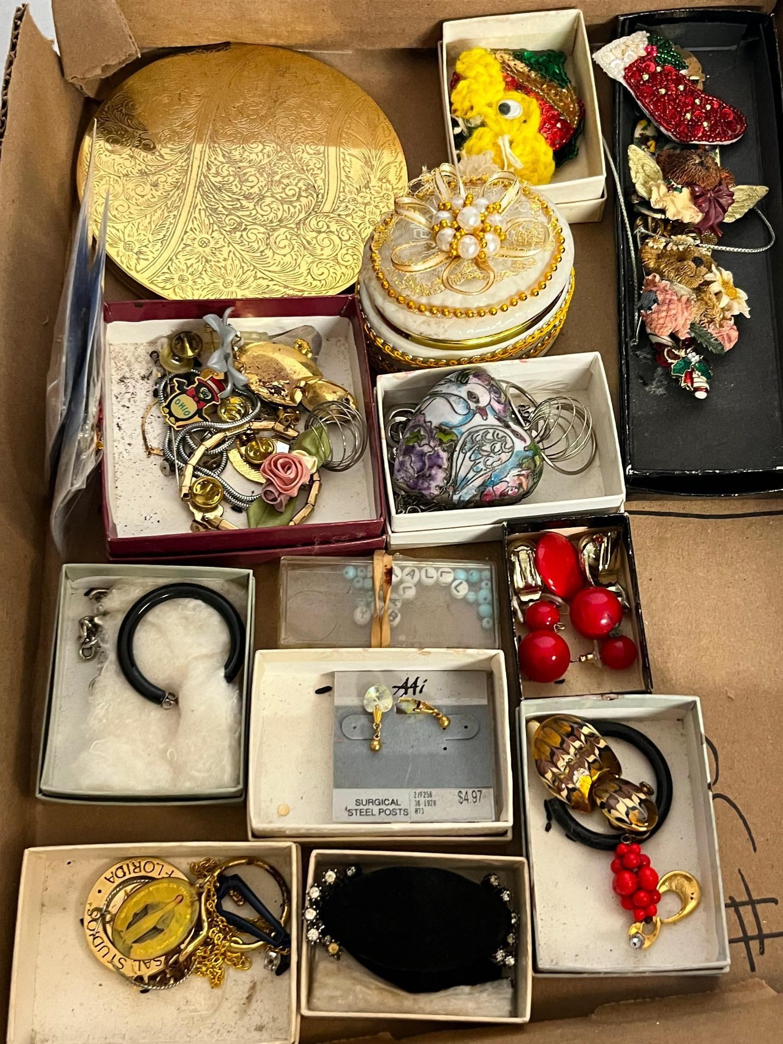 Costume Jewelry & Trinket Boxes: This lot comprises a collection of mid-to-late 20th-century costume jewelry and small decorative objects. A pair of faceted clear heart-shaped earrings remains on a gray retail card bearing a stylized