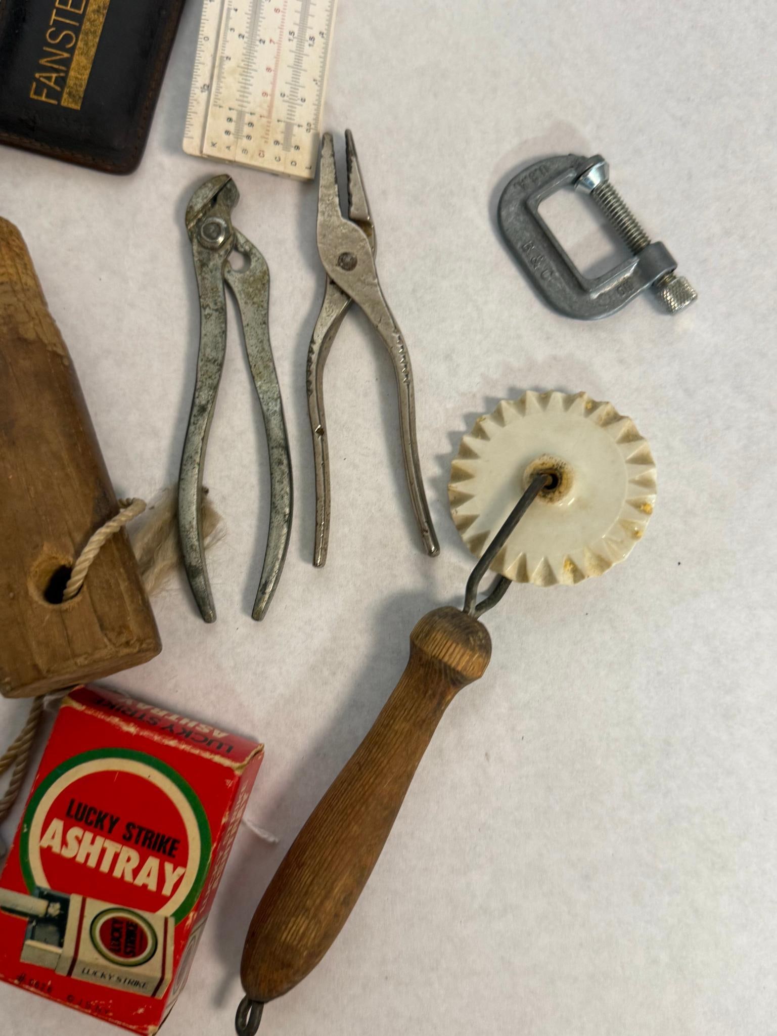 Fansteel & Bostitch Drafting Tools: This collection features various mid-20th-century tools and related industrial ephemera. A white slide rule is contained in a brown leather sleeve with gold-stamped lettering that reads FANSTEEL