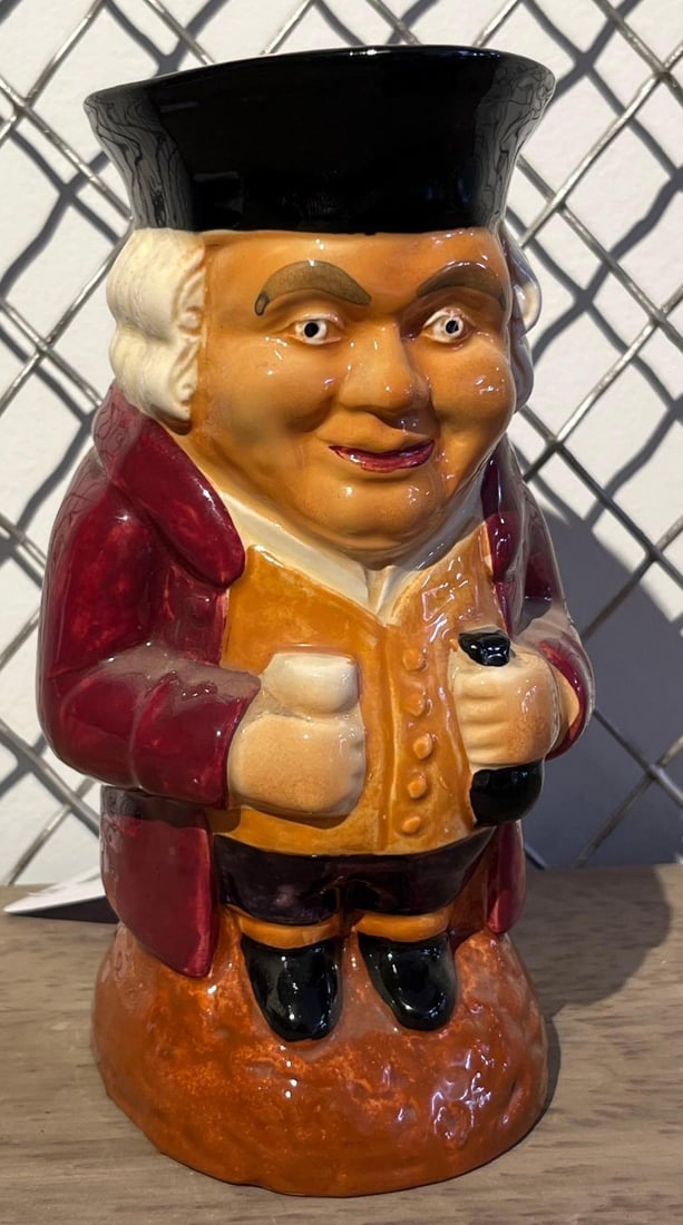 Shorter & Son Crown Devon Toby Jug: An English glazed earthenware character jug produced by Shorter and Son and marketed under the Crown Devon brand. The vessel is modeled as a full standing male figure in 18th-century attire, with a bl