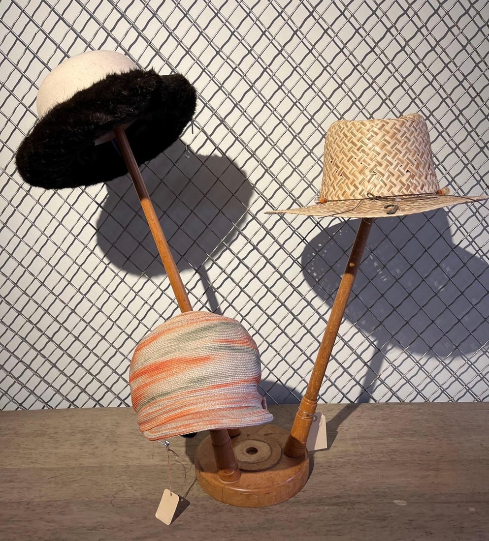 3 Christian Dior & Derby Hats & Stand: This lot consists of three women's hats and a three-tier wooden hat stand. The first hat is a multi-colored horizontal striped cloche fashioned from knit or woven straw in shades of orange, cream, and