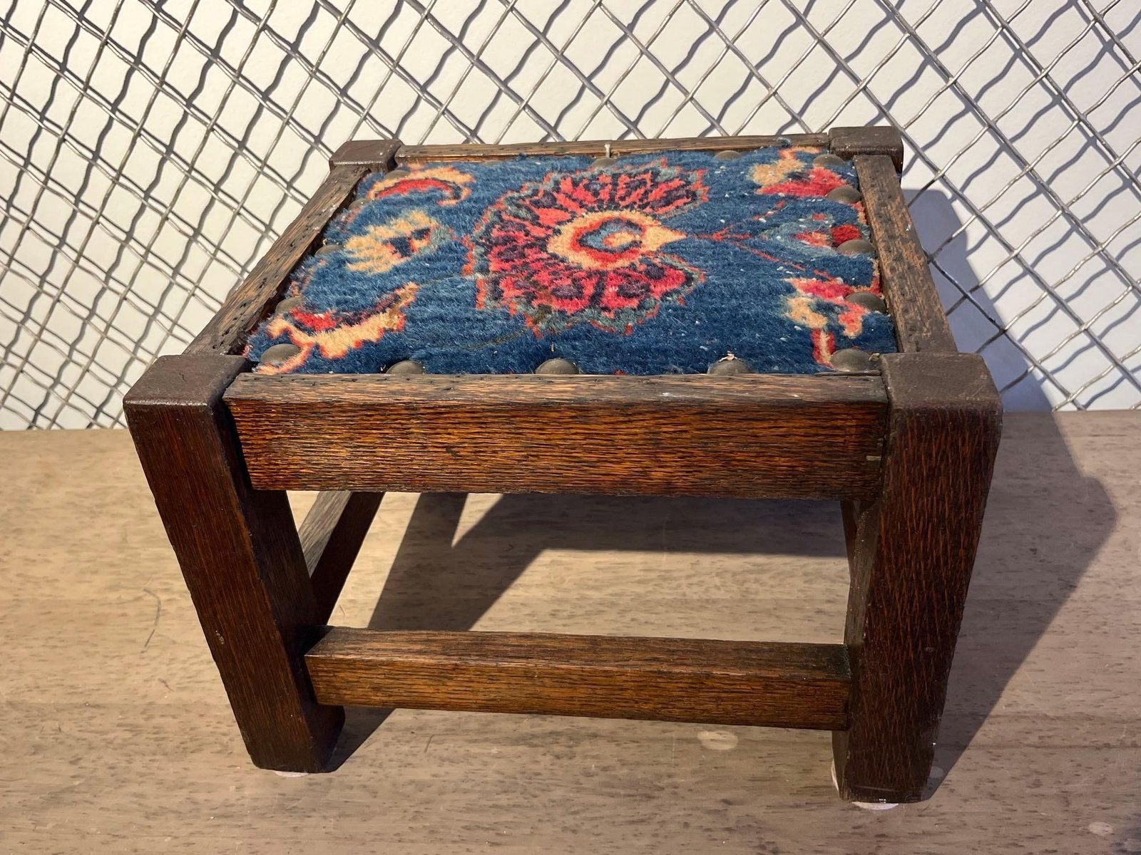 Mission Style Oak Footstool w/ Carpet: An Arts and Crafts style footstool constructed from quarter-sawn oak, displaying characteristic medullary ray flecking throughout the grain. The design follows classic Mission lines with four square-s