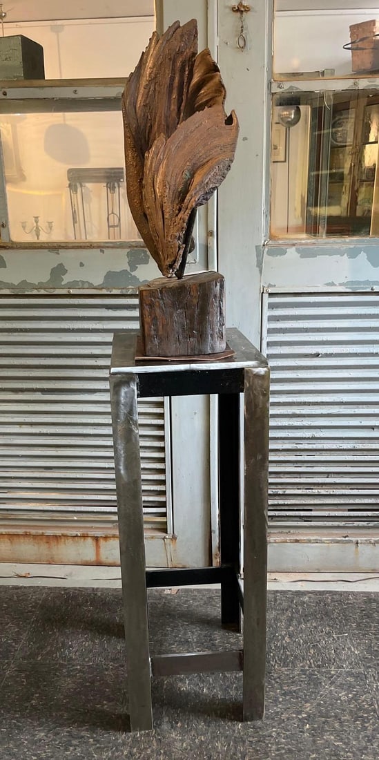 Abstract Organic Sculpture & Steel Base: A large floor-standing abstract sculpture featuring a vertically oriented organic form with deeply textured, layered folds. The primary component is constructed from a heavy textured material, likely 