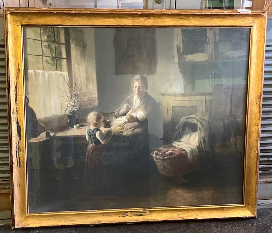 Bernard de Hoog, Mothers Happiness, O/C: This oil on canvas interior scene is executed in the atmospheric Hague School style. The composition features a mother seated at a wooden table, feeding an infant in her lap while a young child in a