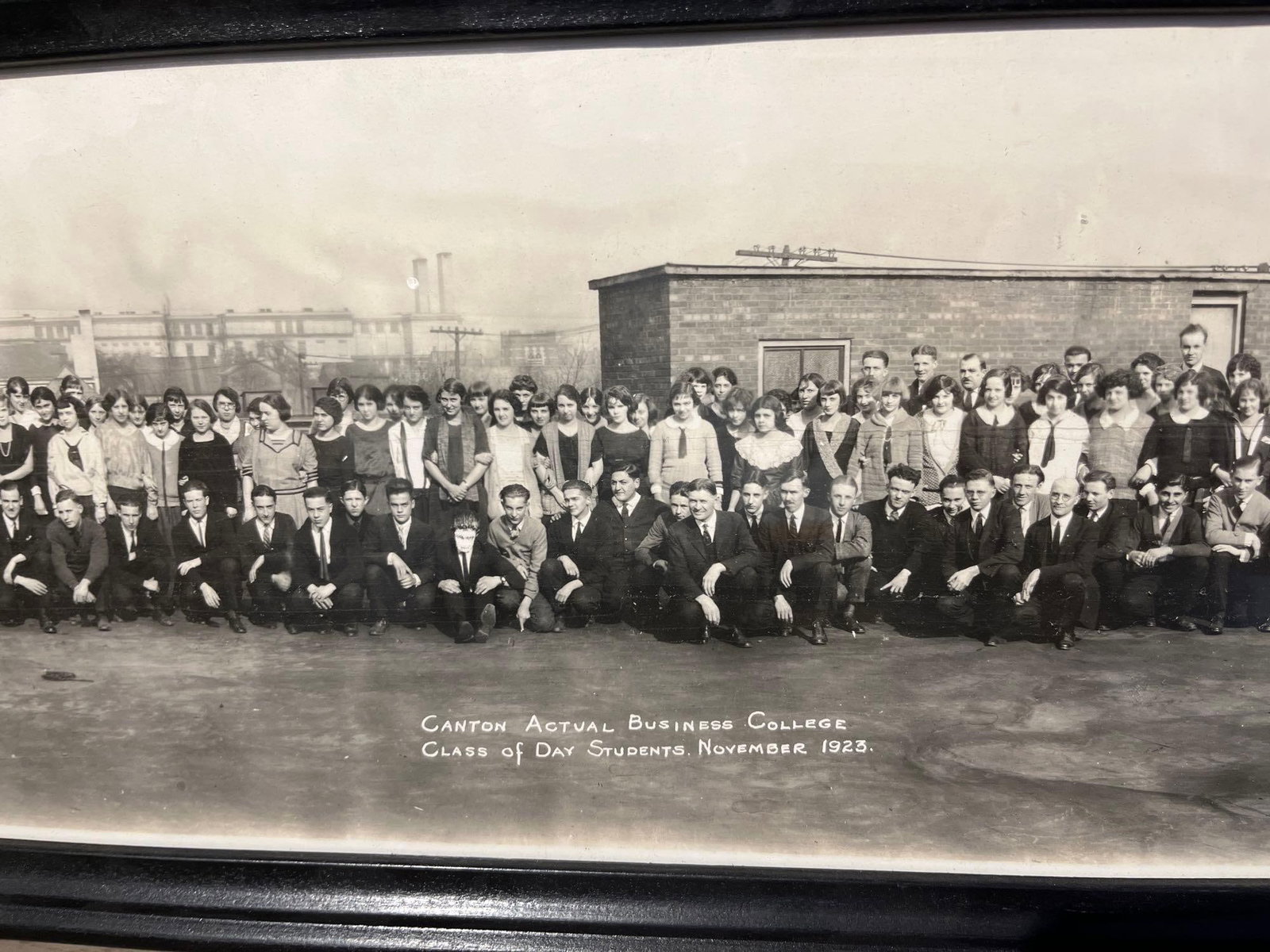 Canton Business College Pan. Photo 1923: This lot consists of a large-format silver gelatin panoramic photograph capturing the class of day students at the Canton Actual Business College, dated November 1923. The image shows a large outdoor