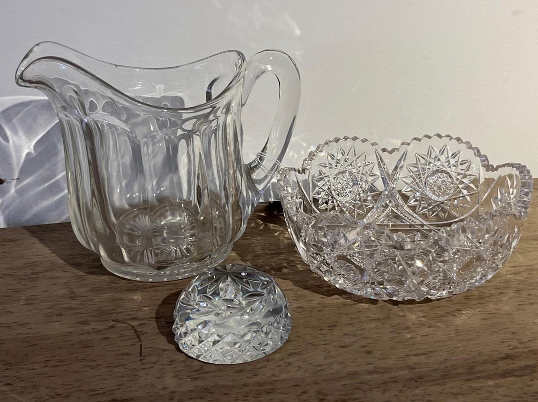 Trio Cut Glass Bowl & Fluted Pitcher: This collection consists of three individual pieces of decorative glass. The first item is a circular lead crystal bowl featuring elaborate deeply cut patterns. The decoration includes multi-pointed