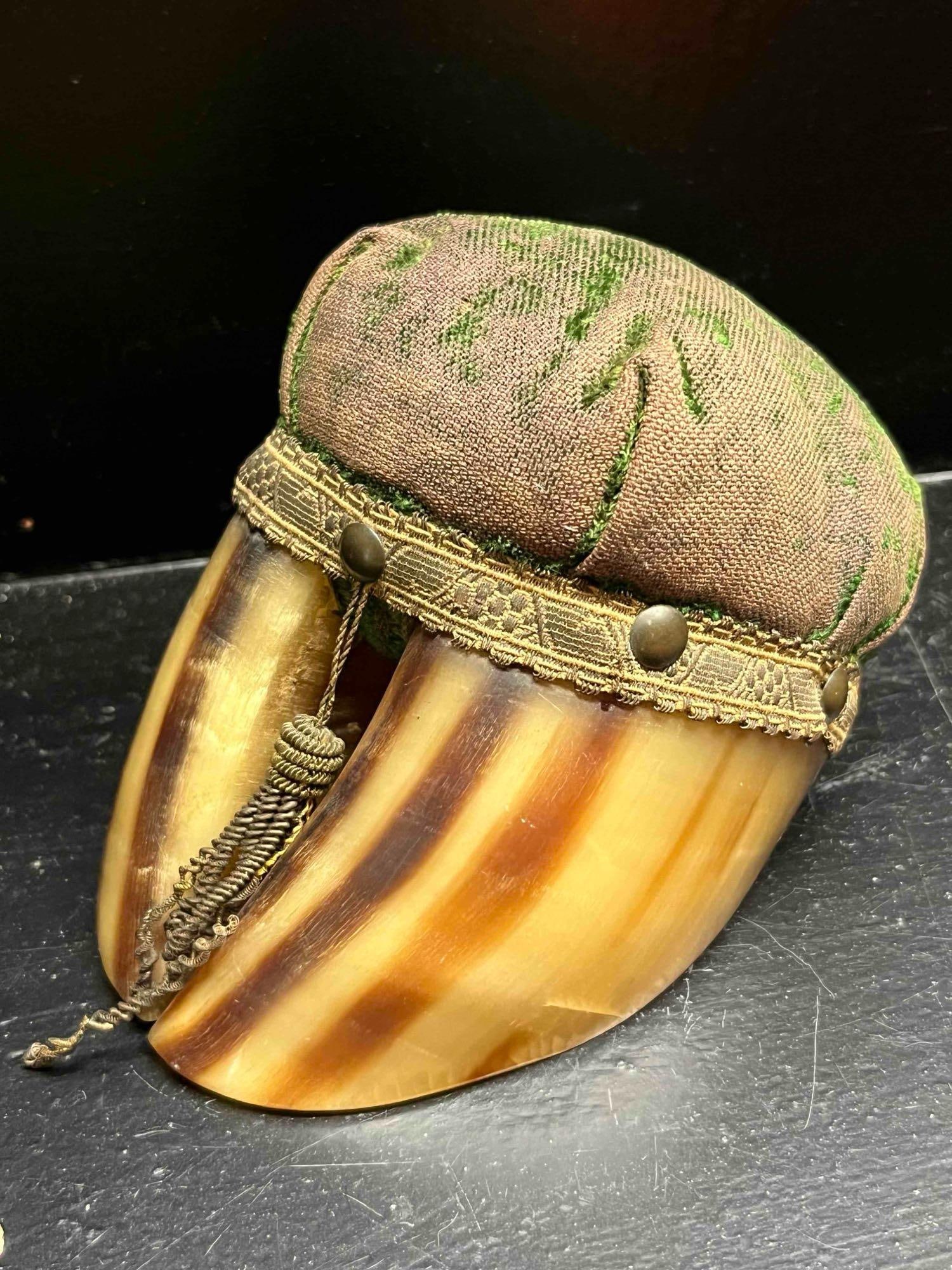 Victorian Bovine Hoof Pincushion: A Victorian-era novelty pincushion constructed with a polished taxidermy cloven hoof as the base. The hoof, likely from a bovine or large deer species, features a translucent honey-colored appearance 