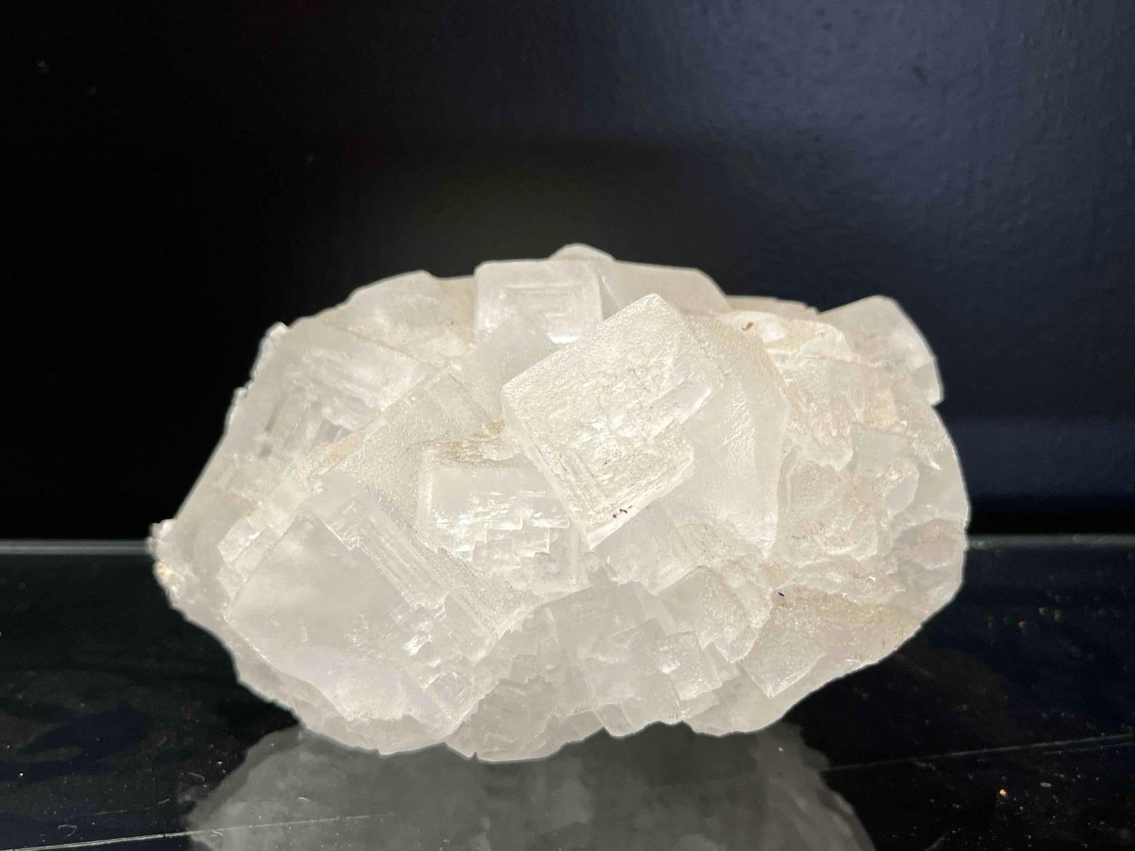 Large Cubic Halite Mineral Specimen: This is a natural halite (rock salt) mineral specimen featuring a dense cluster of interlocking cubic crystals. The specimen demonstrates a classic isometric crystal habit with well-defined 90-degree 