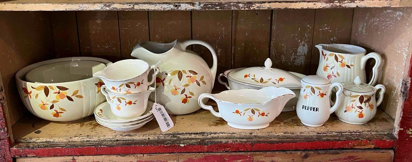 Hall China Autumn Leaf Jewel Tea Set: This assortment of semi-vitreous ceramic tableware is decorated in the Autumn Leaf pattern, which features transfer-printed stylized vines with leaves and buds in shades of burnt orange, yellow, and b