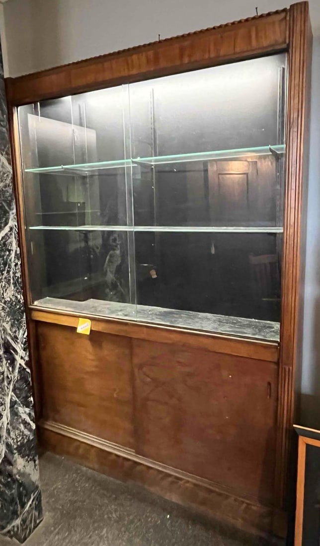 Art Deco Arch. Display Cabinet w/ Doors: A large architectural display cabinet constructed from hardwood with figured wood veneers, reflecting mid-20th-century design with Art Deco influences. The piece features a two-part composition housed