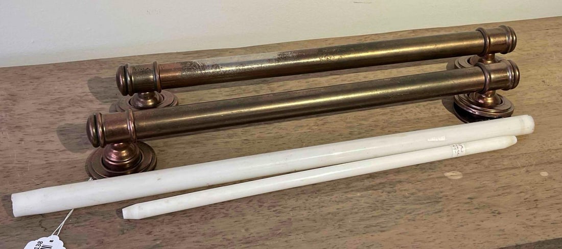 Pair Bronze and Ceramic Towel Racks: A pair of matching tubular metal towel holders. They are finished in a dark oil-rubbed bronze style over a lighter base metal.. Overall length of holders are 22 inches Length of white: 21