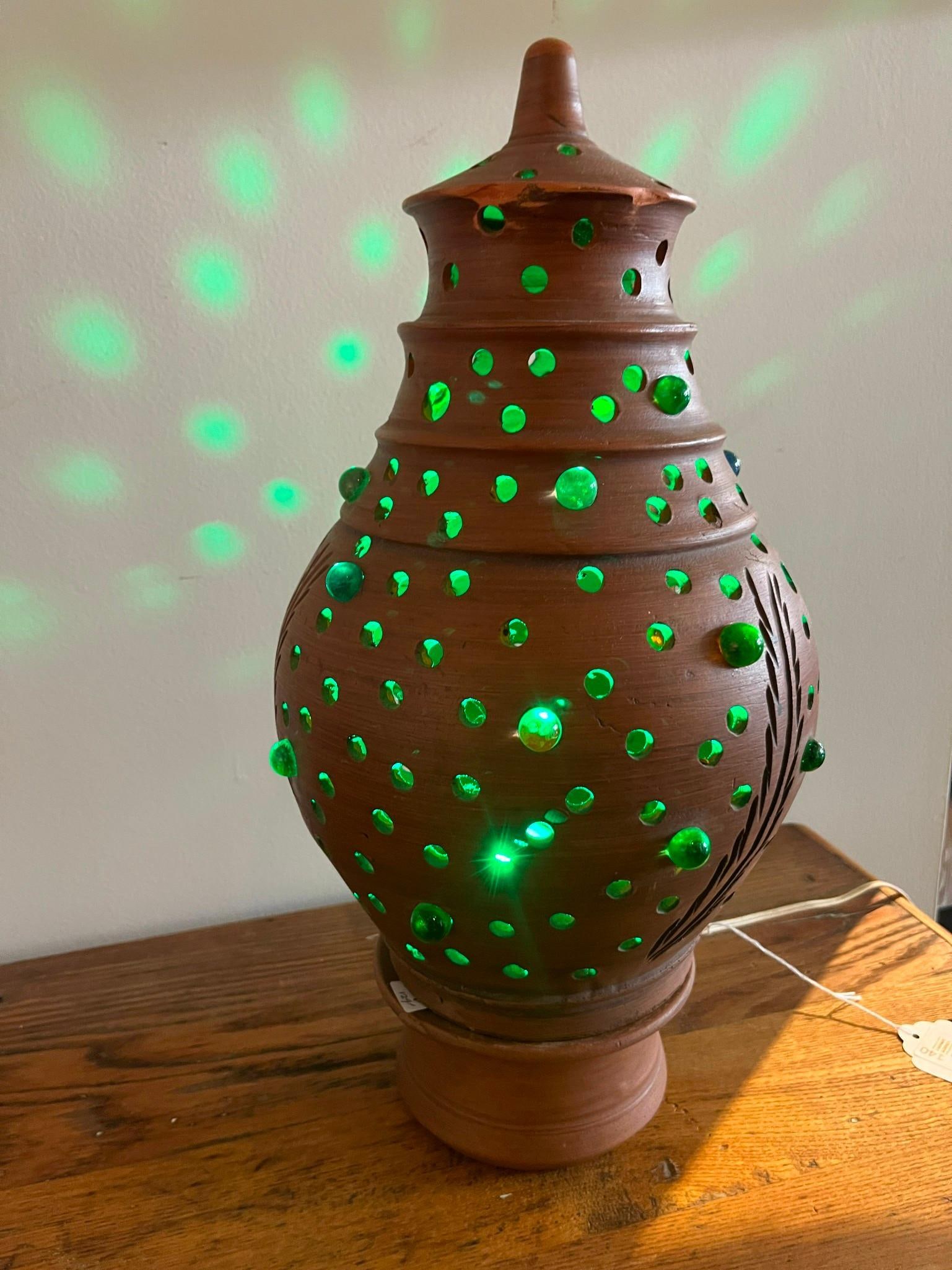 Pierced Terracotta Lamp & Glass Marbles: An electric table lamp constructed from unglazed redware terracotta, featuring a tiered ovoid body resting on a separate flared circular base. The lamp is topped with a removable, pointed lid. The