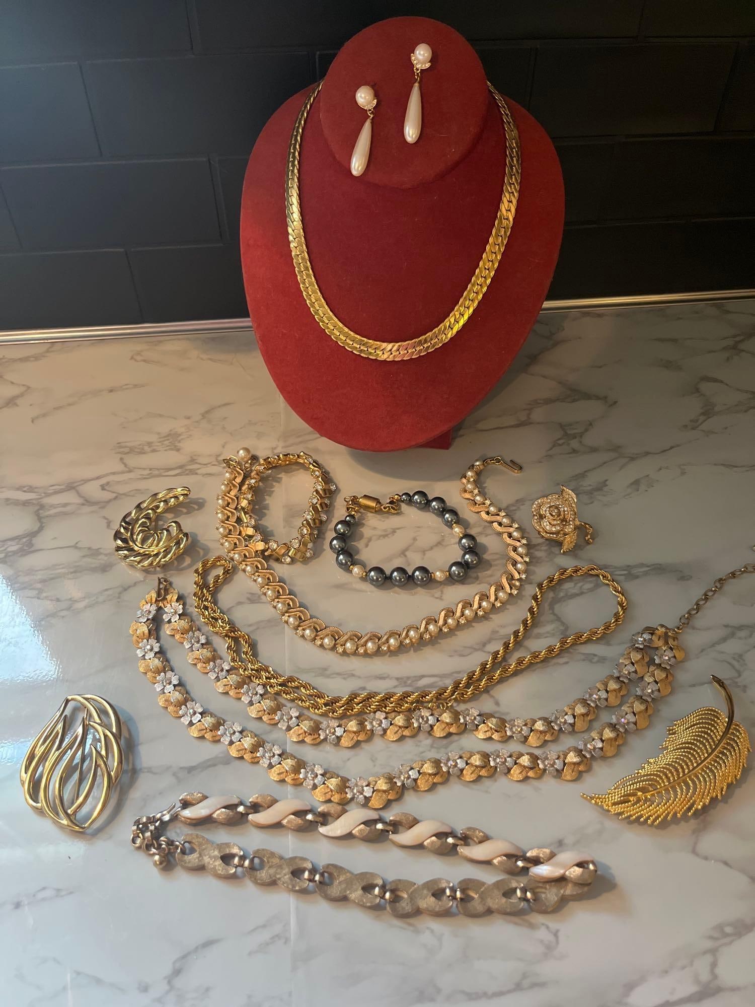 Monet & Kramer Pearl/Gold-Tone Jewelry: This group of mid-to-late 20th-century costume jewelry is composed of base metals in gold-tone and silver-tone finishes, featuring faux pearls, glass rhinestones, and enamel accents. The collection
