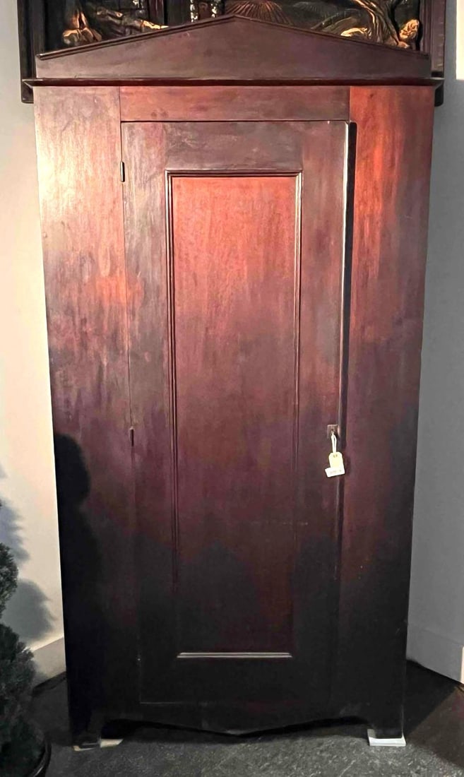 Zoar Single Door Hardwood Wardrobe: This hardwood wardrobe is constructed in a single piece from a dark-toned wood, likely cherry or walnut, featuring a deep reddish-brown finish. The cabinet features a single door with a large recessed