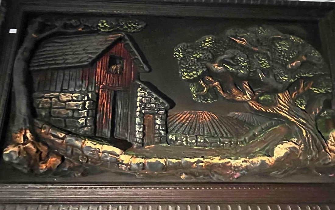 Americana Rural Scene Polychrome Relief: This cast composite high-relief wall sculpture depicts a rustic Americana rural scene. The composition features a red barn with a stone foundation, positioned next to a gnarled, spreading tree and a l
