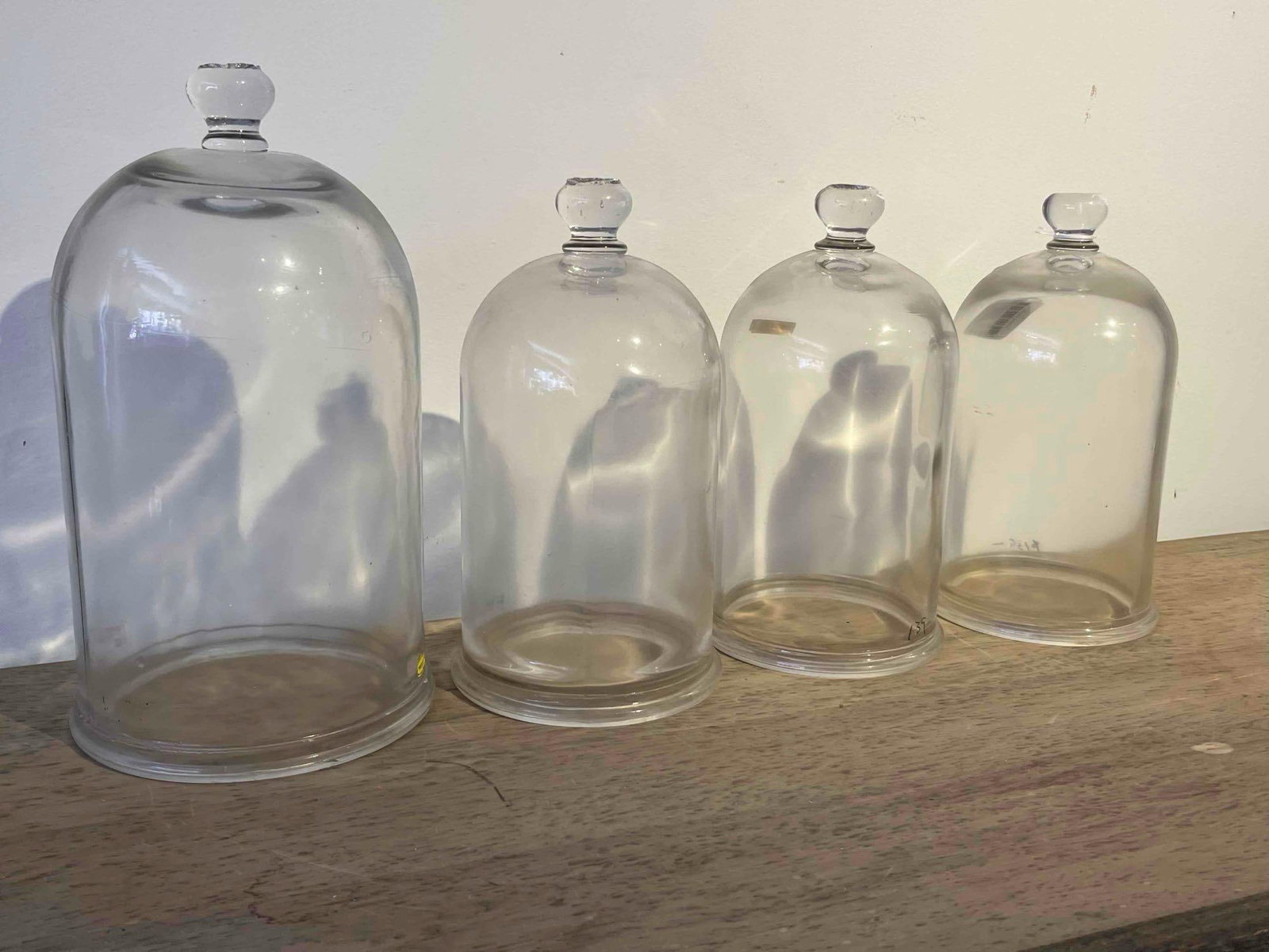 Set 4 MISCO Graduated Glass Bell Jars: A set of four clear glass bell jars of graduated sizes, originally intended for scientific or laboratory use. Each vessel is constructed with a cylindrical body and a domed top surmounted by a solid