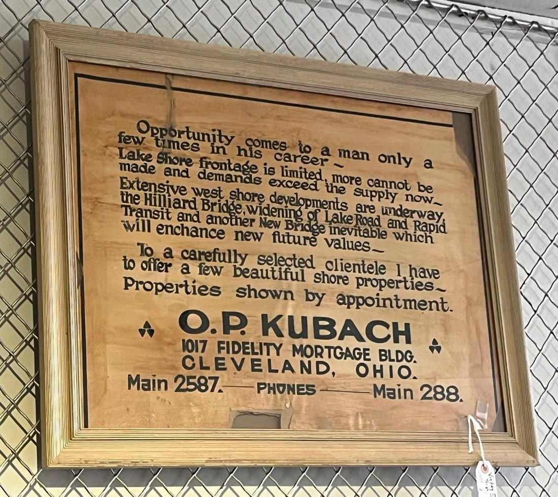O.P. Kubach Cleveland Realty Wood Sign: A real estate advertisement sign for Cleveland broker O.P. Kubach, dating to the mid-1920s. The piece is printed in black ink on a surface of thin wood veneer or heavy textured paperboard. The text