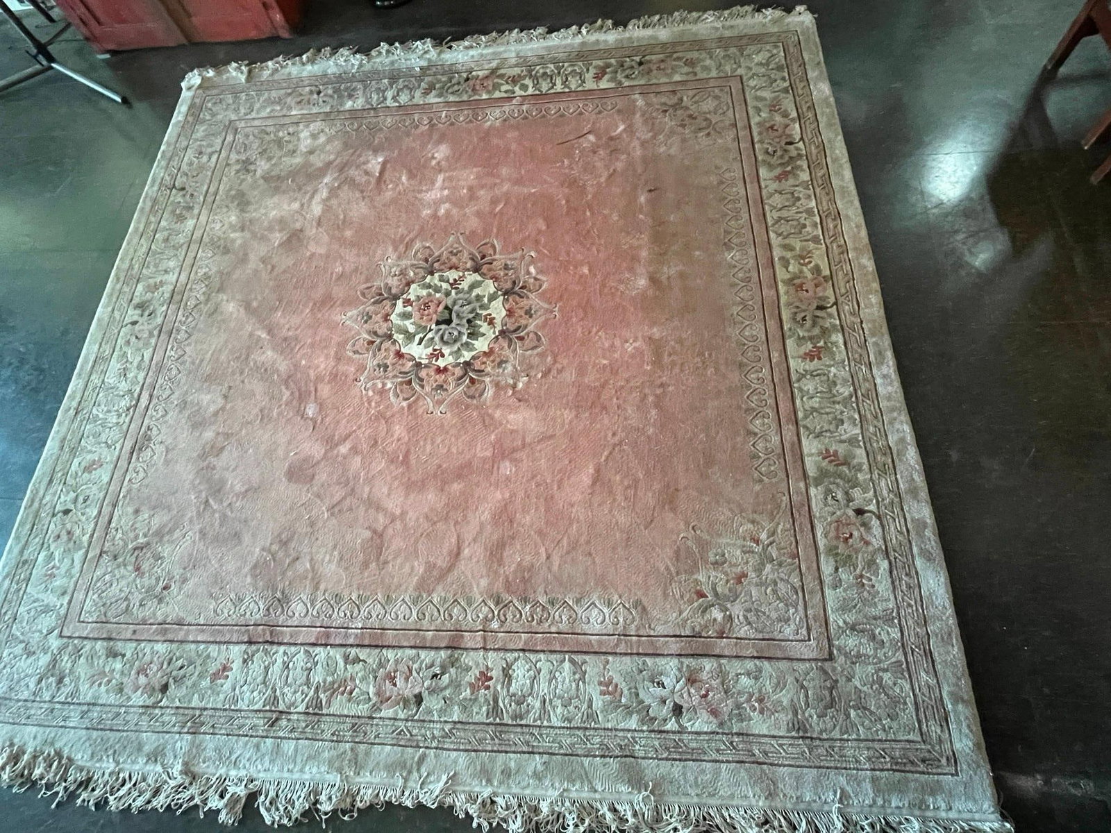 Chinese Art Deco Wool Rug w/ Medallion: A Chinese Art Deco style sculpted rug featuring a dense wool pile hand-knotted on a cotton foundation. The design consists of an open, solid-color rose-pink field centered by a hand-carved floral meda