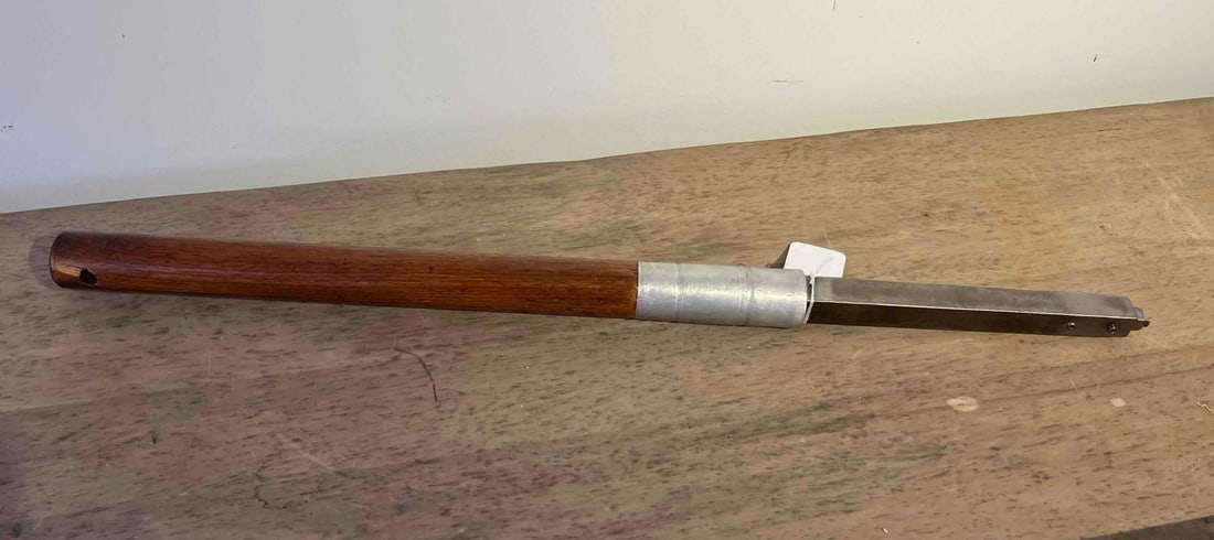Carbide-Tipped Wood Lathe Roughing Tool: A woodturning tool designed for use on a lathe, primarily used for roughing and shaping timber. The tool consists of a long, turned hardwood handle finished with a dark stain and a high-gloss