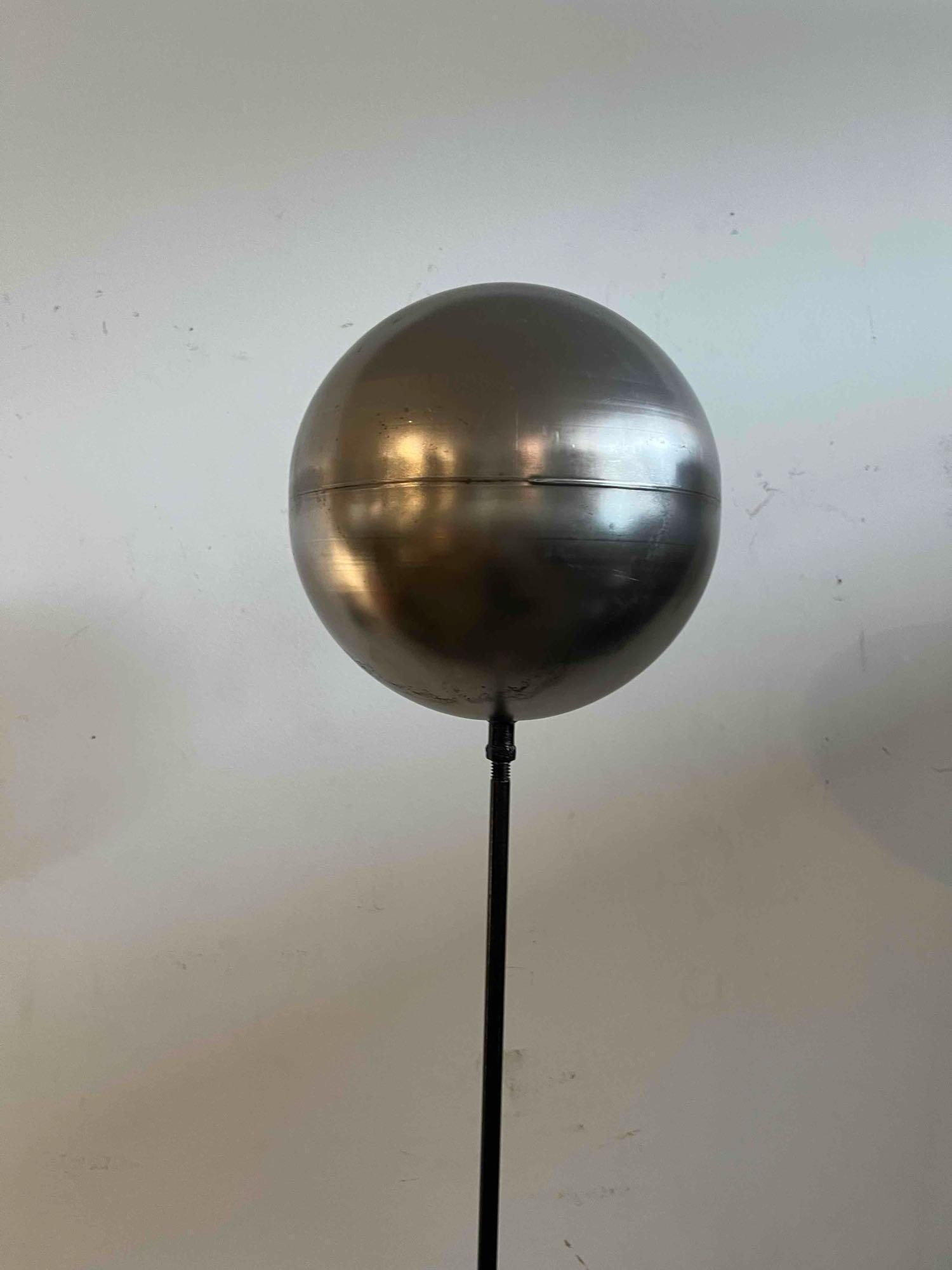 Space Age Mixed Metal Sphere Statement Piece: Featuring a mixed-metal construction in a minimalist Space Age style. The sculpture is supported by a circular, domed base with a chrome finish, which leads to a slender chrome-finished lower pole.