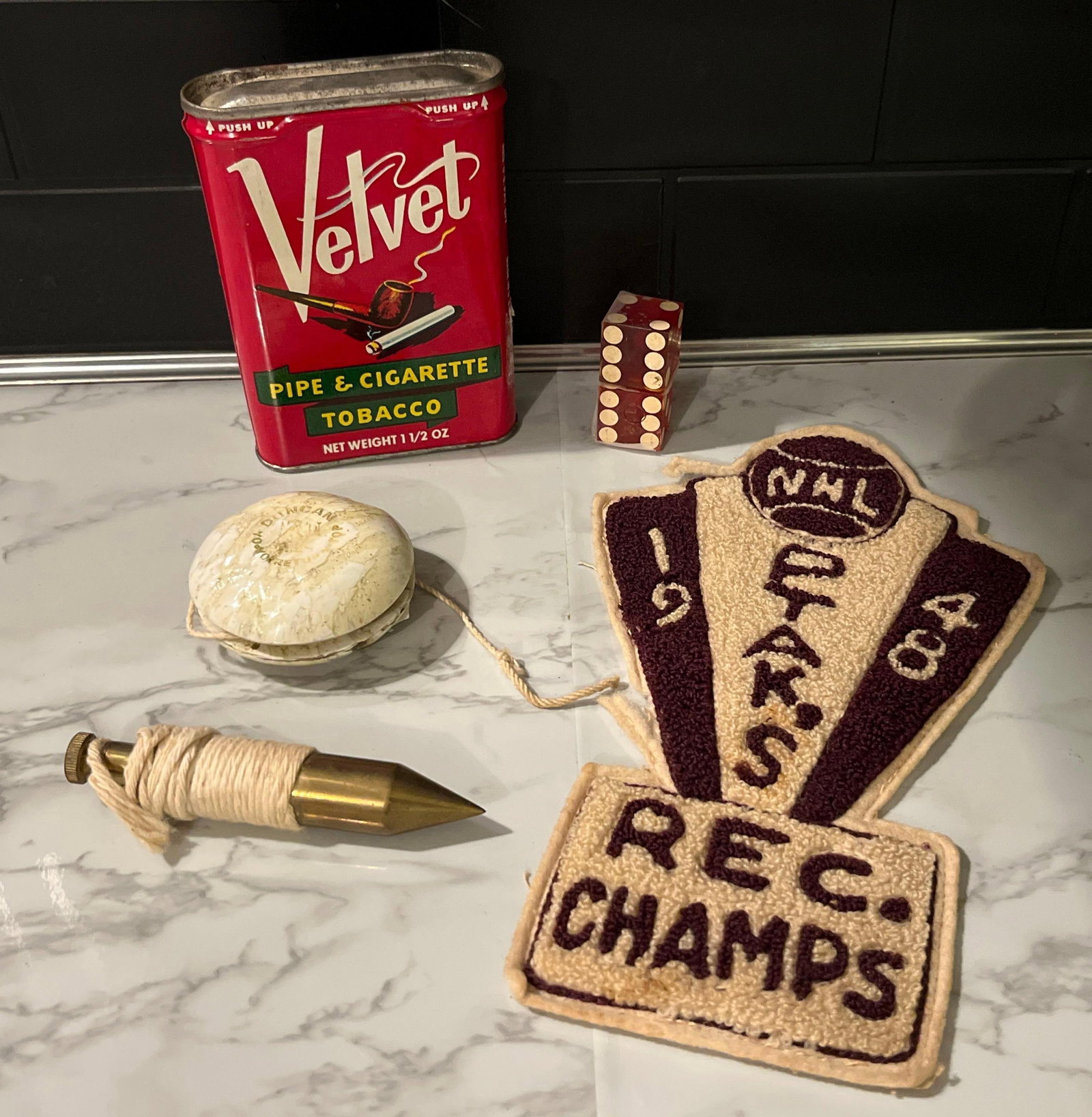 Chenille Patch & Velvet Tobacco Tin: This lot comprises an assortment of items including sports memorabilia, toys, tools, and tobacciana. The sports patch is a large chenille and felt trophy-style award. It features a dark red and cream 