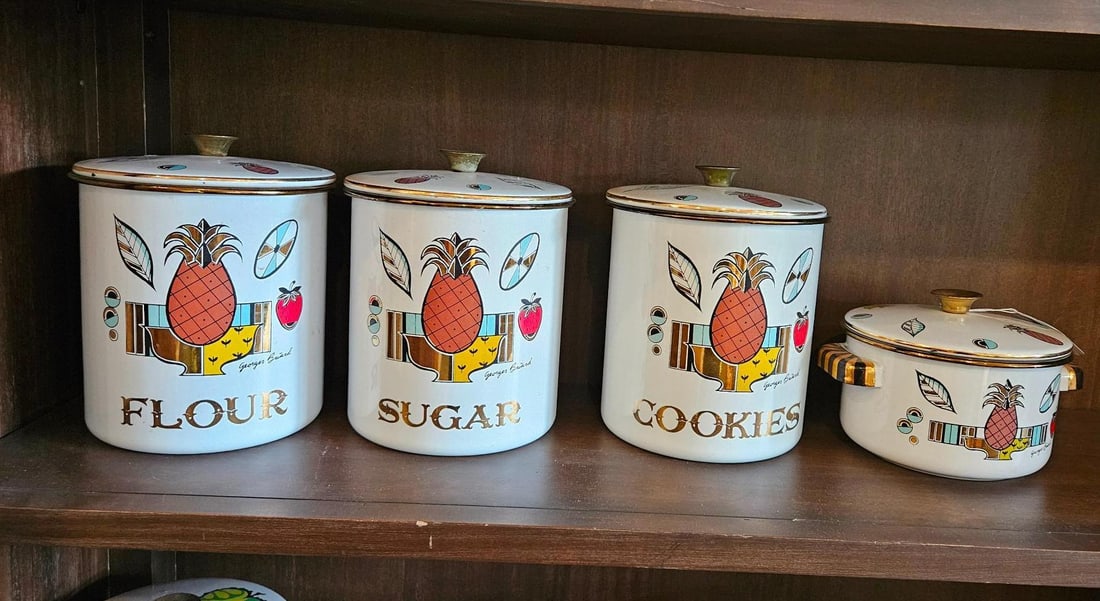 Georges Briard Enamel Canisters & Pot: A set of mid-century modern white enameled metal kitchenware designed by Georges Briard. The set includes three graduated canisters and one small lidded pot with two handles. The exterior of each piec