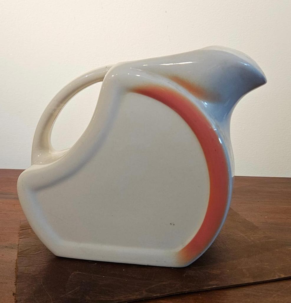 Wallace China Streamline Drip Pitcher: A ceramic pitcher manufactured by Wallace China in Los Angeles, California. The piece is constructed from vitreous china and features a distinct Streamline Moderne aesthetic with a geometric, semi-tri