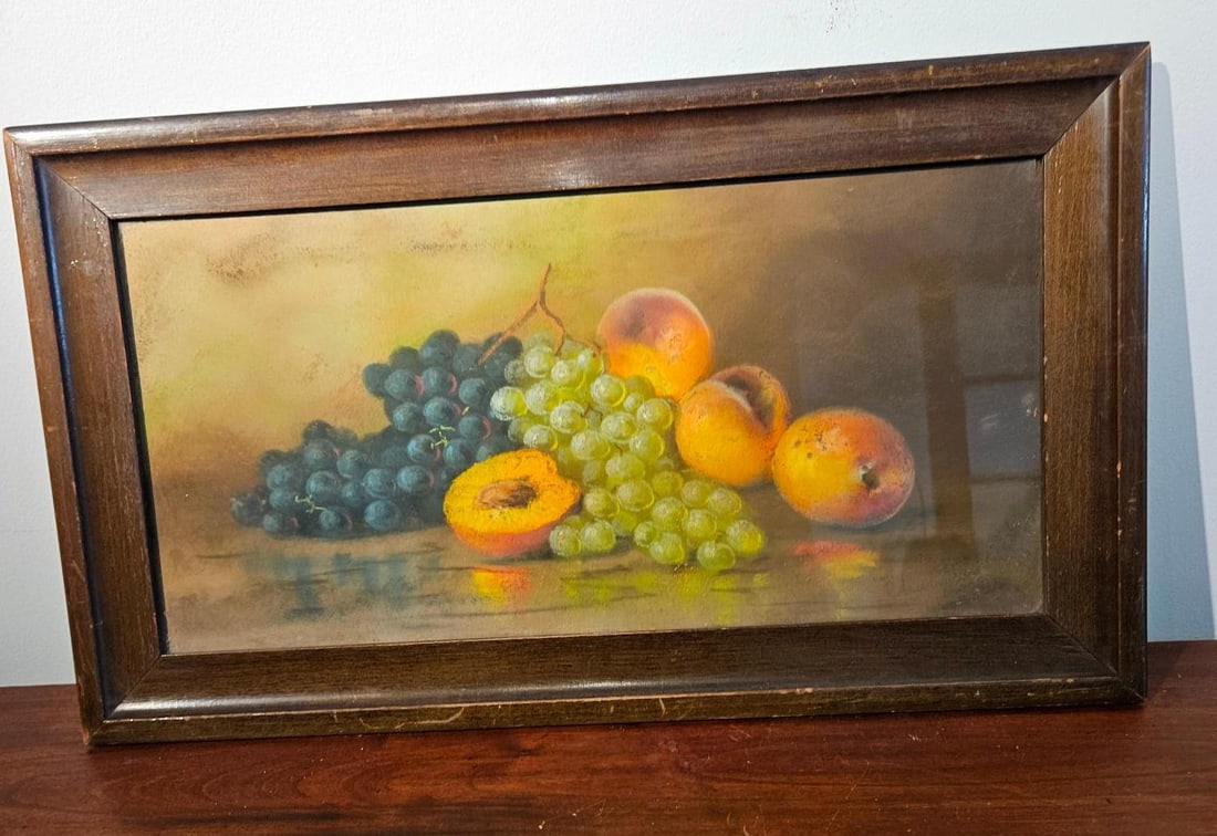 American School Pastel Fruit Still Life: This horizontal still life composition is rendered in vibrant pastel on toned paper, depicting a cluster of dark purple and light green grapes alongside three peaches or apricots. One of the stone fru