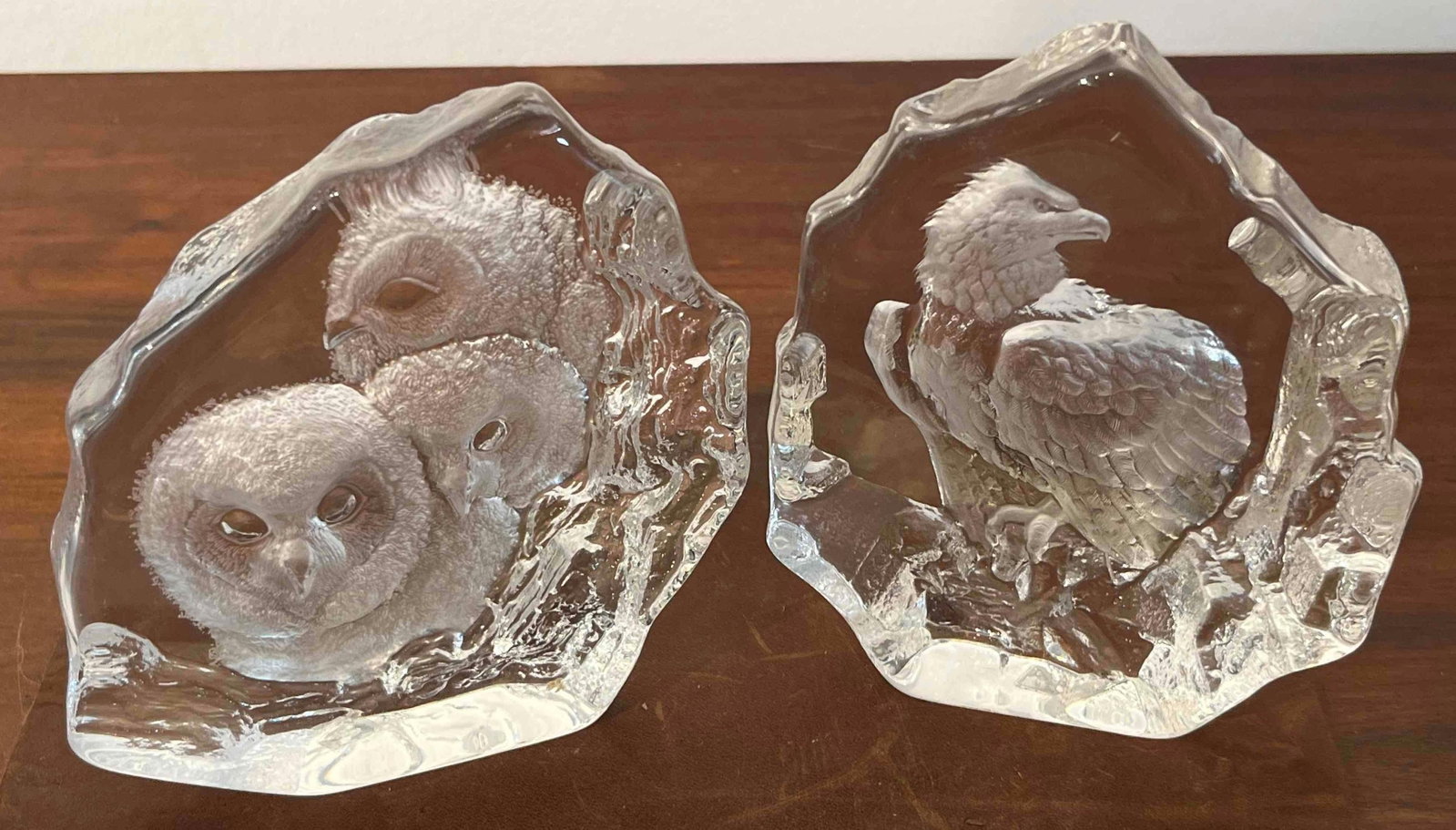 Pair Mats Jonasson Wildlife Sculptures: A pair of Swedish full lead crystal art glass sculptures featuring wildlife subjects. Each piece is constructed from a clear crystal block with an irregular, ice-like textured perimeter surrounding a 
