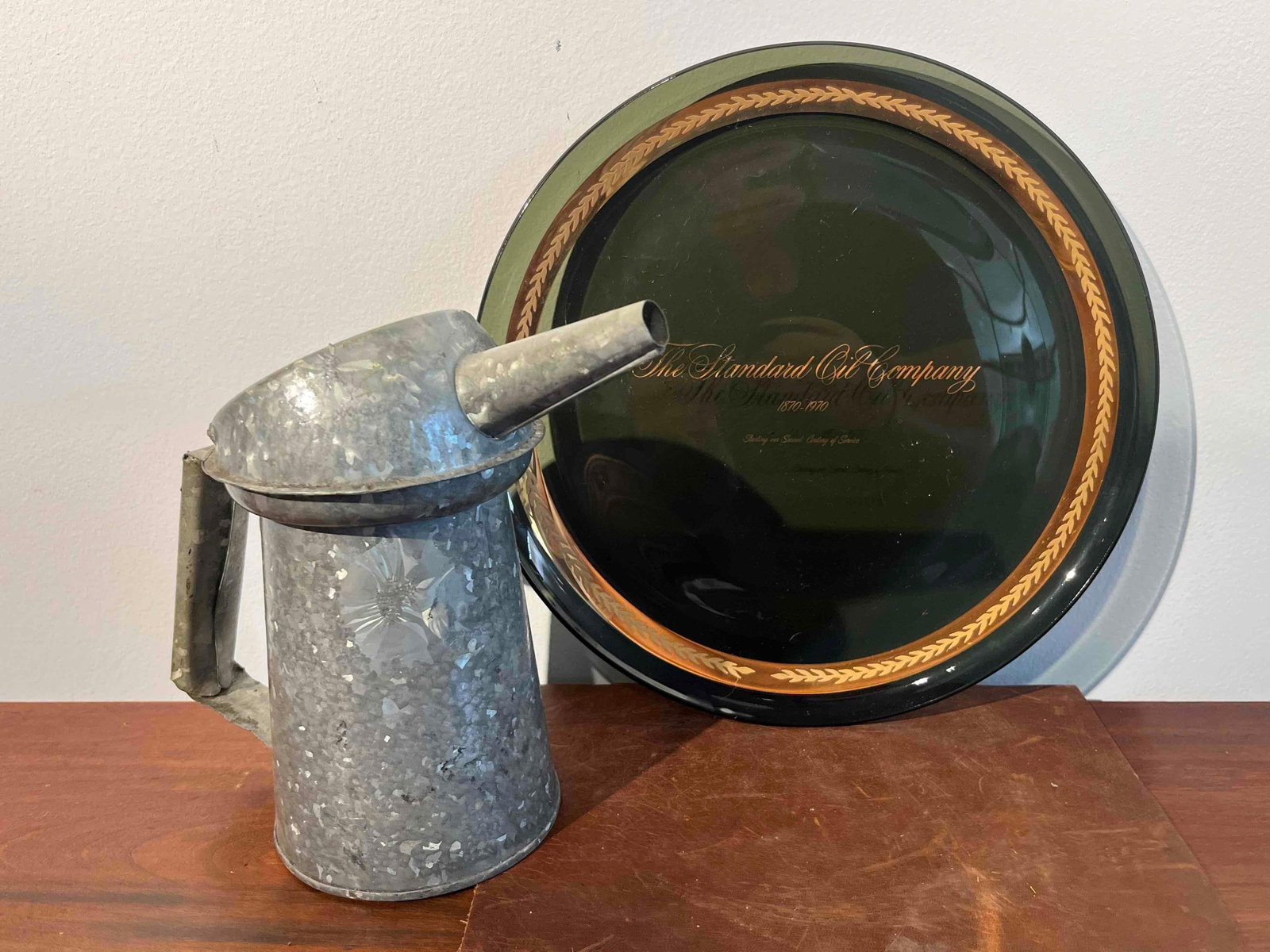 Standard Oil Centennial Plate & Pourer: This lot consists of two pieces of automotive-related memorabilia. The first is a commemorative glass plate produced for The Standard Oil Company to mark its 100th anniversary. The plate is made of da